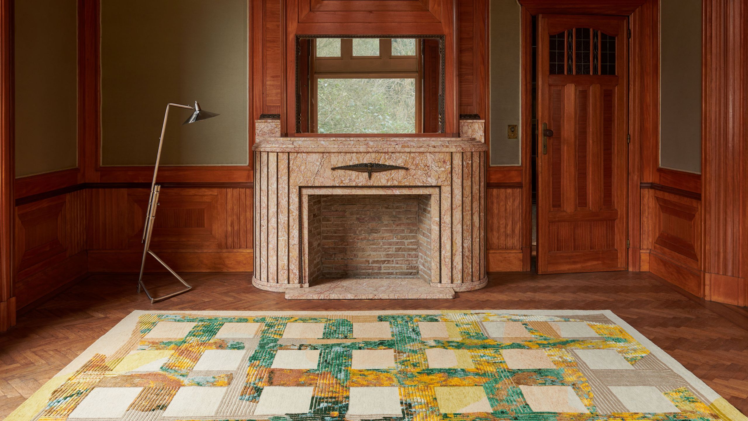 Image may contain: Indoors, Interior Design, Home Decor, Fireplace, Lamp, Floor, Rug, Wood, and Flooring