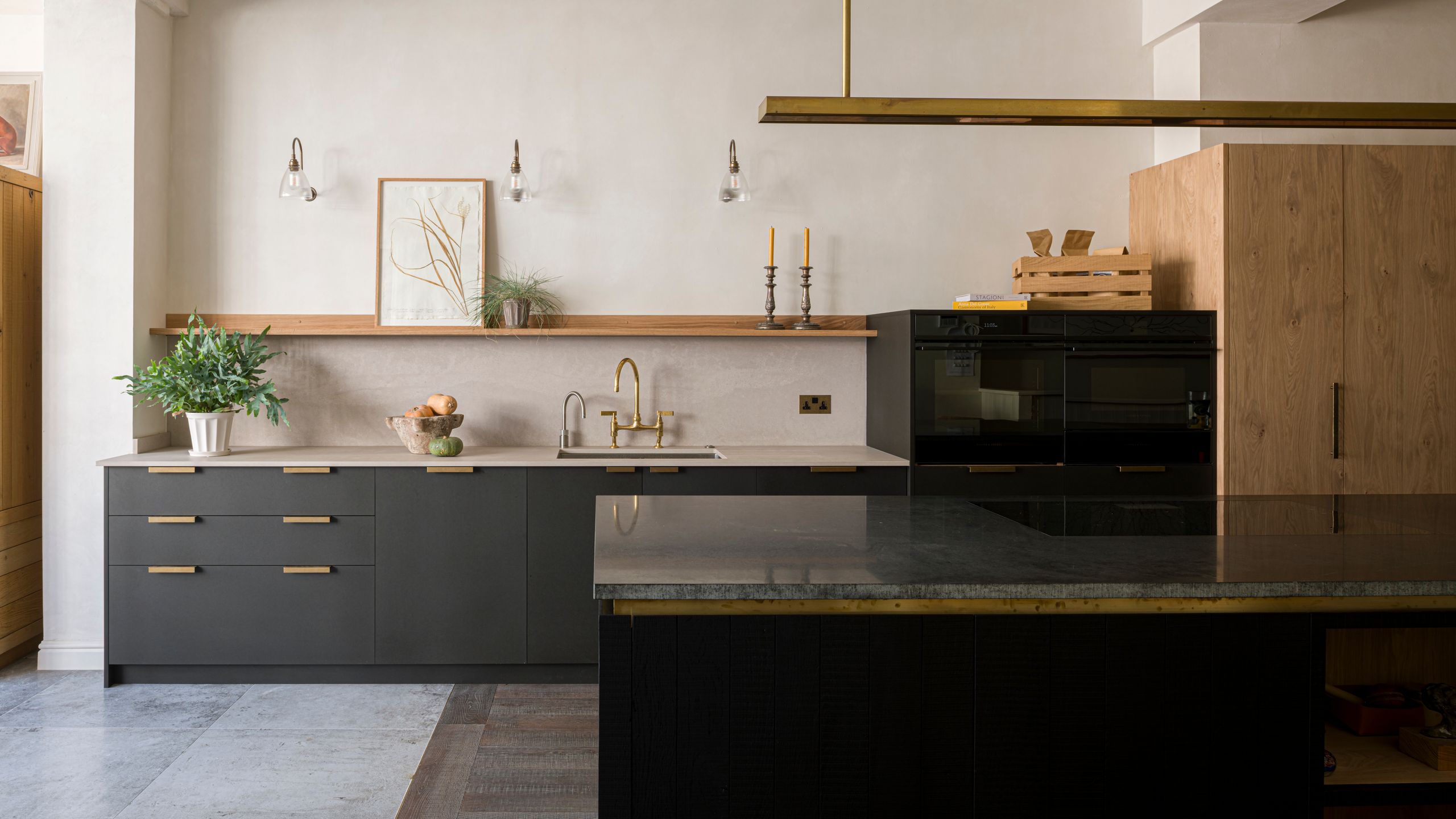 Image may contain: Indoors, Interior Design, Kitchen, Plant, Sink, Sink Faucet, Kitchen Island, Lamp, Cabinet, and Furniture