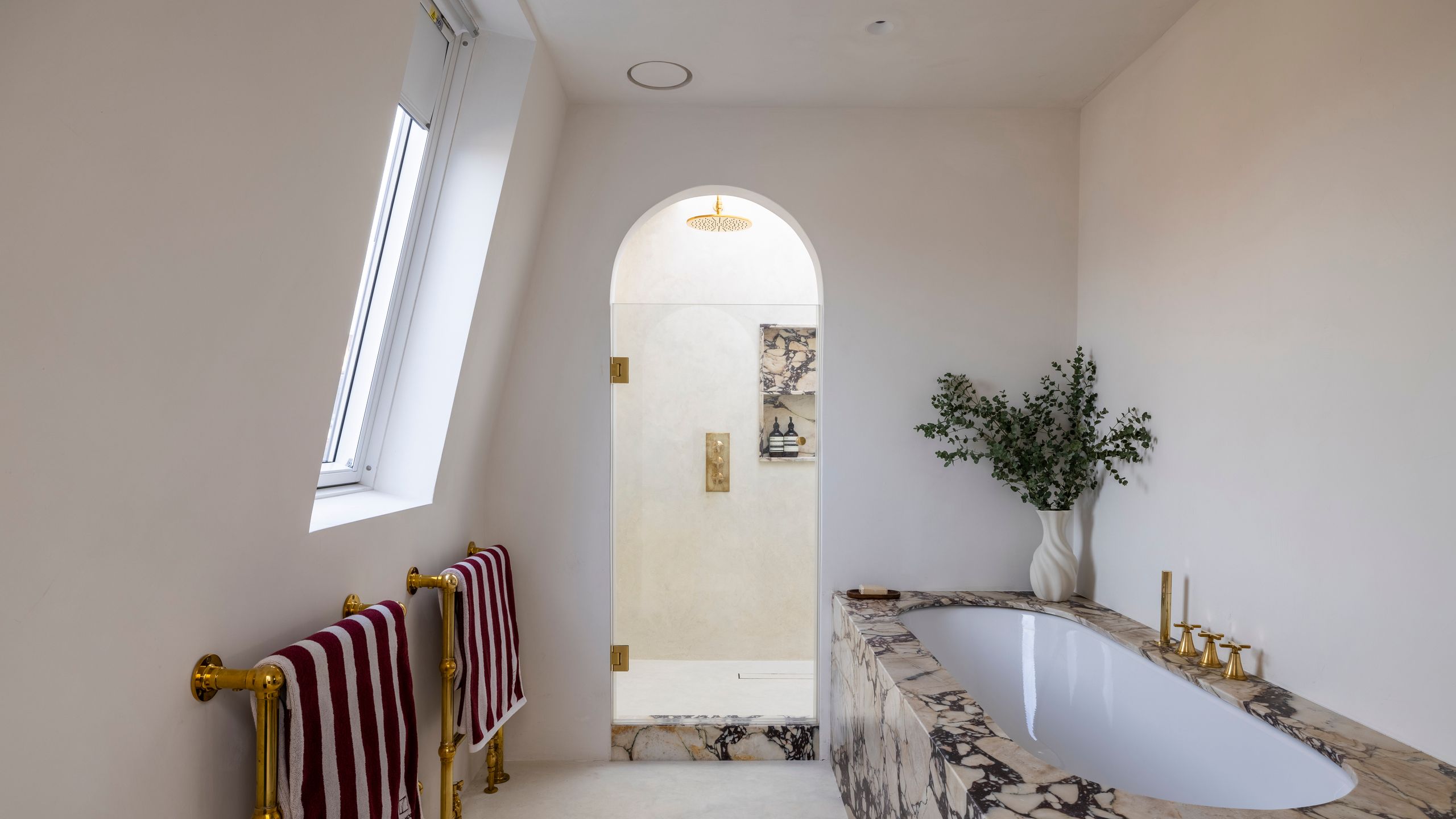 Image may contain: Bathing, Bathtub, Person, Tub, Indoors, Interior Design, and Plant