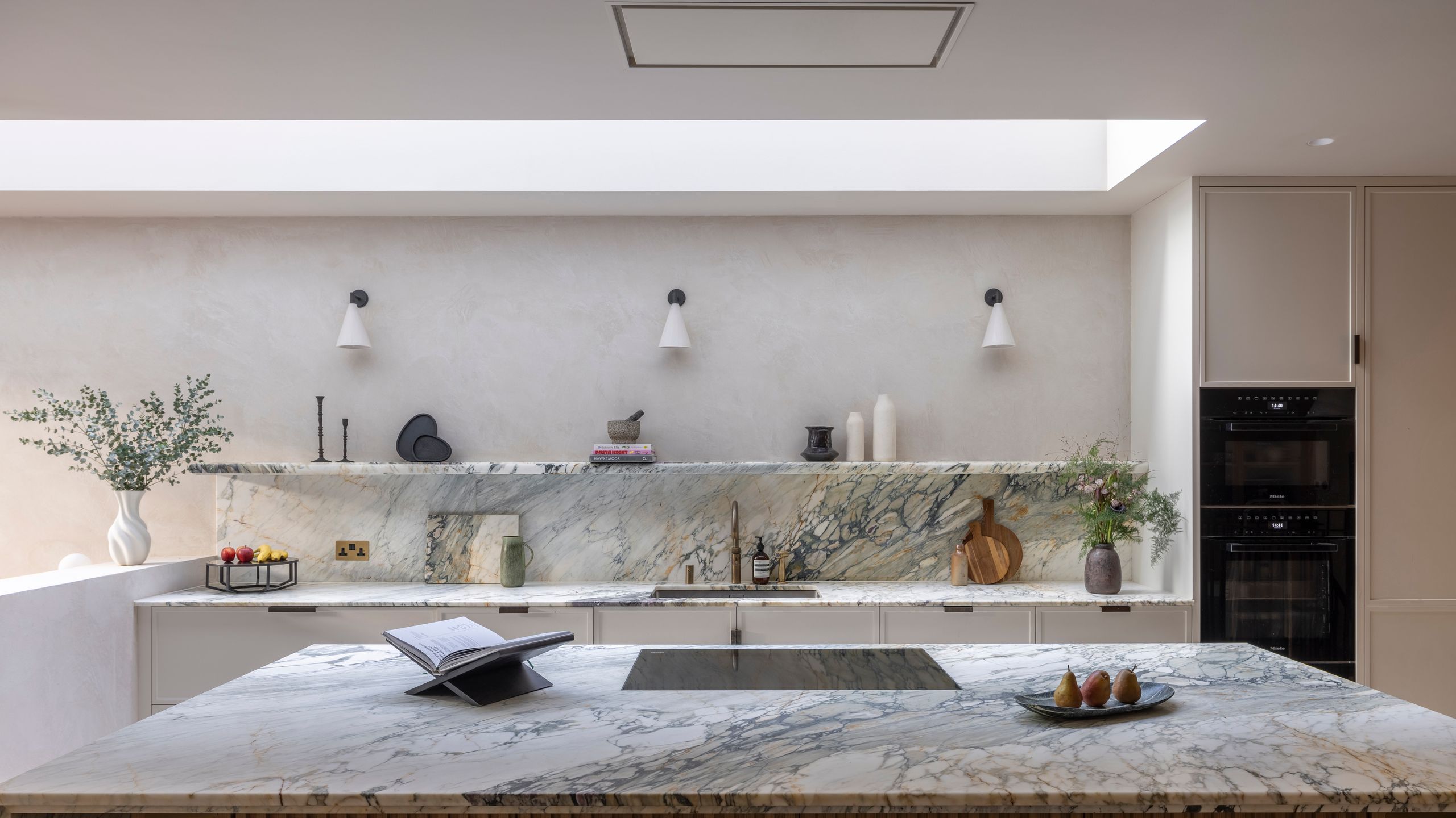 Image may contain: Indoors, Interior Design, Book, Publication, Kitchen, Sink, Sink Faucet, Kitchen Island, Plate, and Lamp