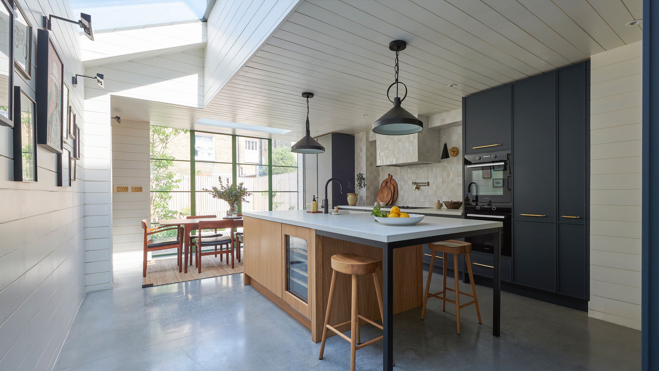 Image may contain: Indoors, Interior Design, Floor, Kitchen, Chair, Furniture, Flooring, Plant, and Kitchen Island