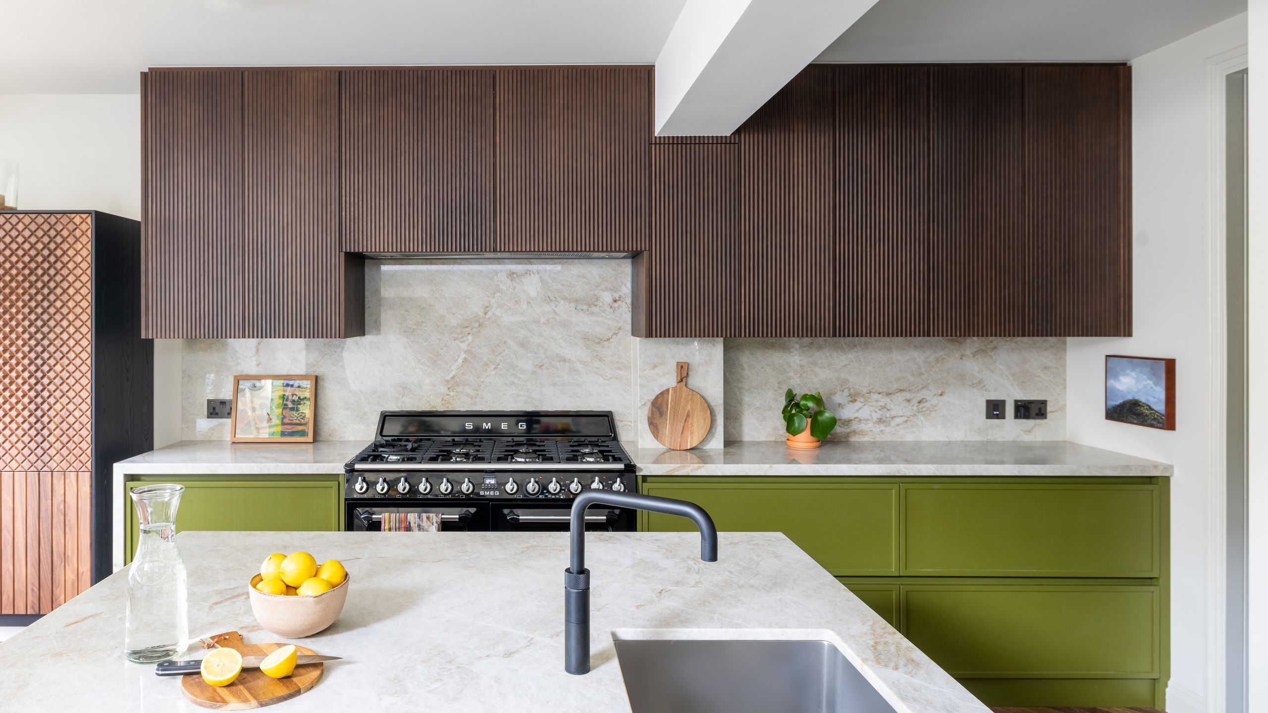 Image may contain: Indoors, Interior Design, Kitchen, Sink, Sink Faucet, Plant, and Cooktop