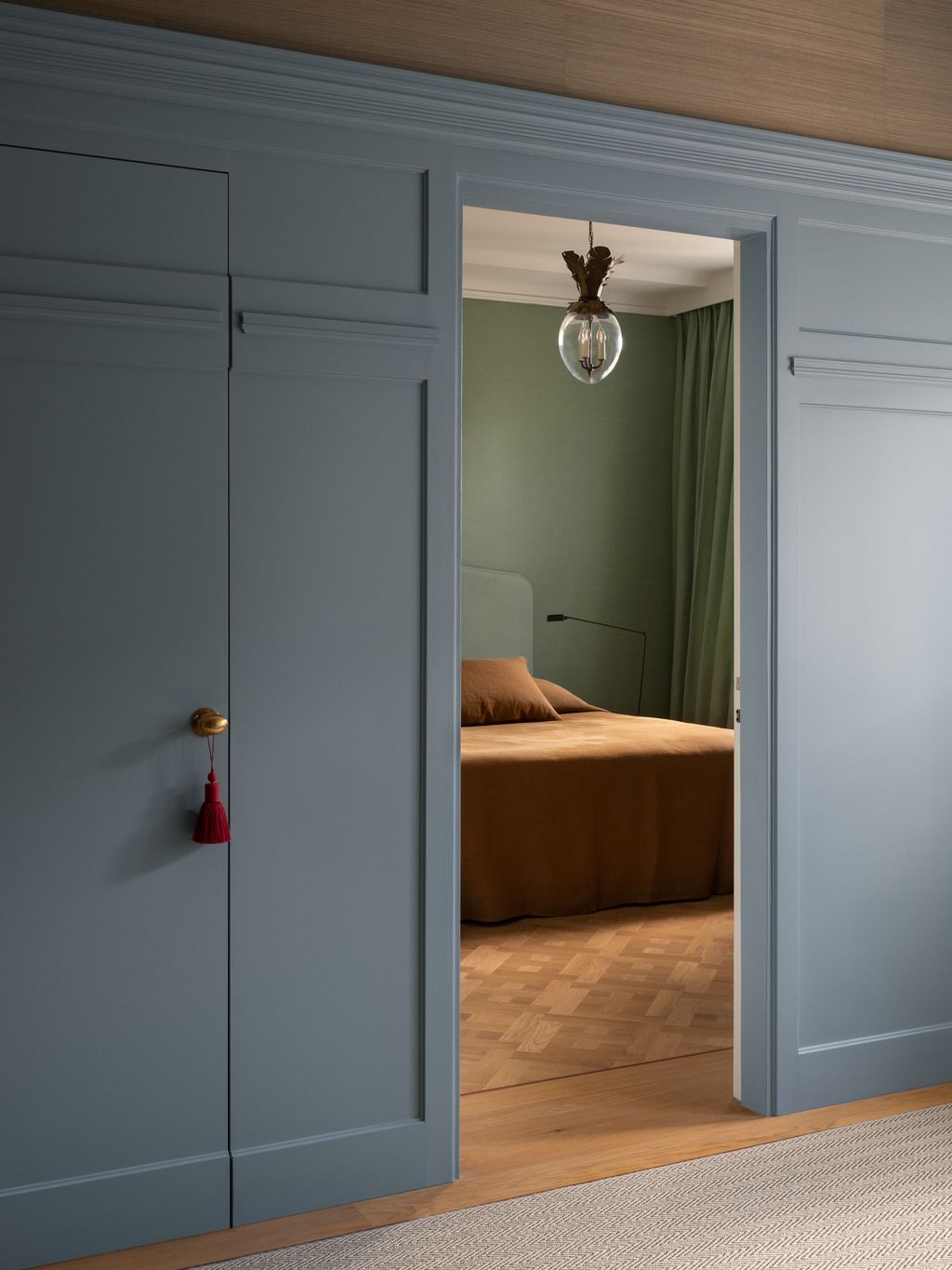 Image may contain Indoors Interior Design Lamp Bed Furniture Door Home Decor Rug Closet and Cupboard