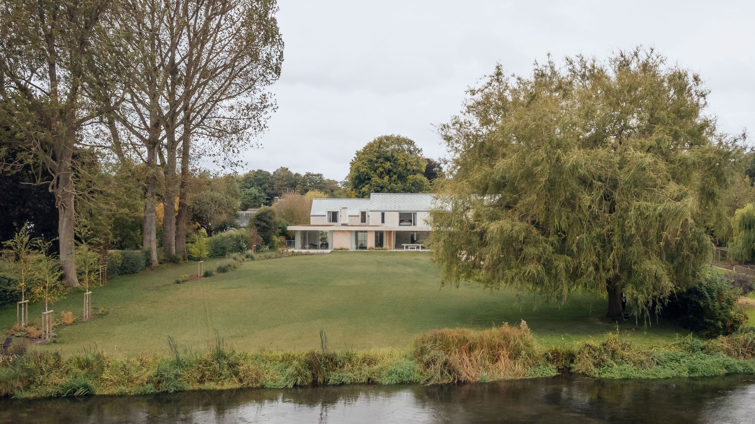 Image may contain: Grass, Plant, Nature, Outdoors, Scenery, Pond, Water, Tree, Vegetation, Waterfront, and Architecture