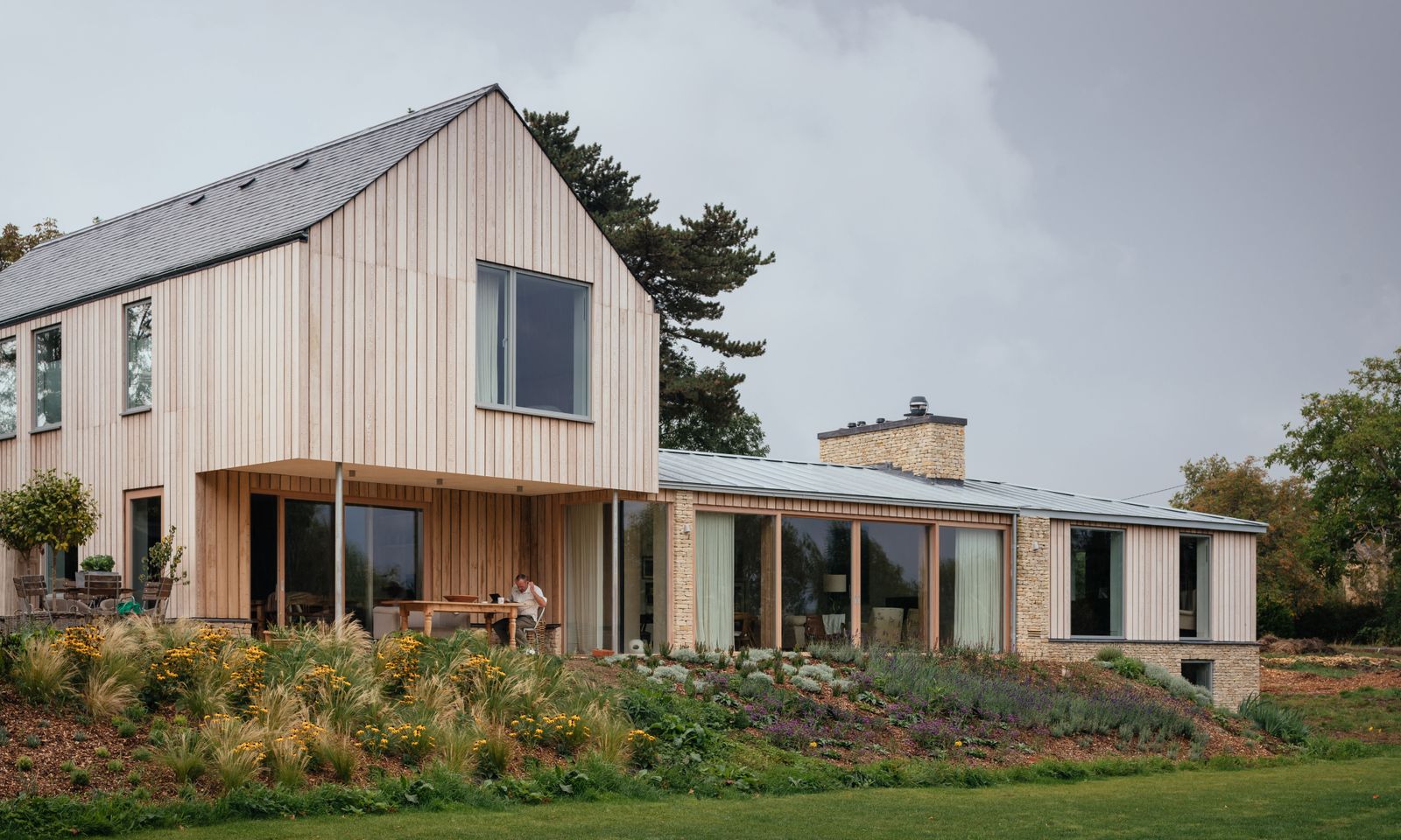 Image may contain Indoors Interior Design Architecture Building Cottage House Housing Grass Plant Person and Lawn