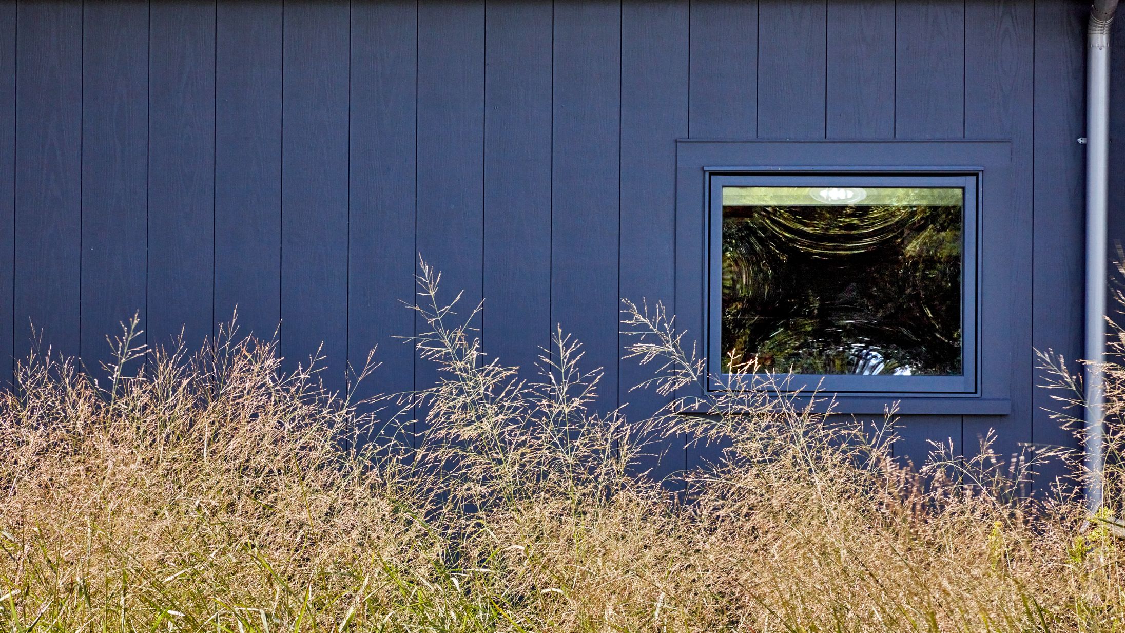 Image may contain: Architecture, Building, Outdoors, Shelter, Indoors, Interior Design, Grass, Plant, Nature, and Window