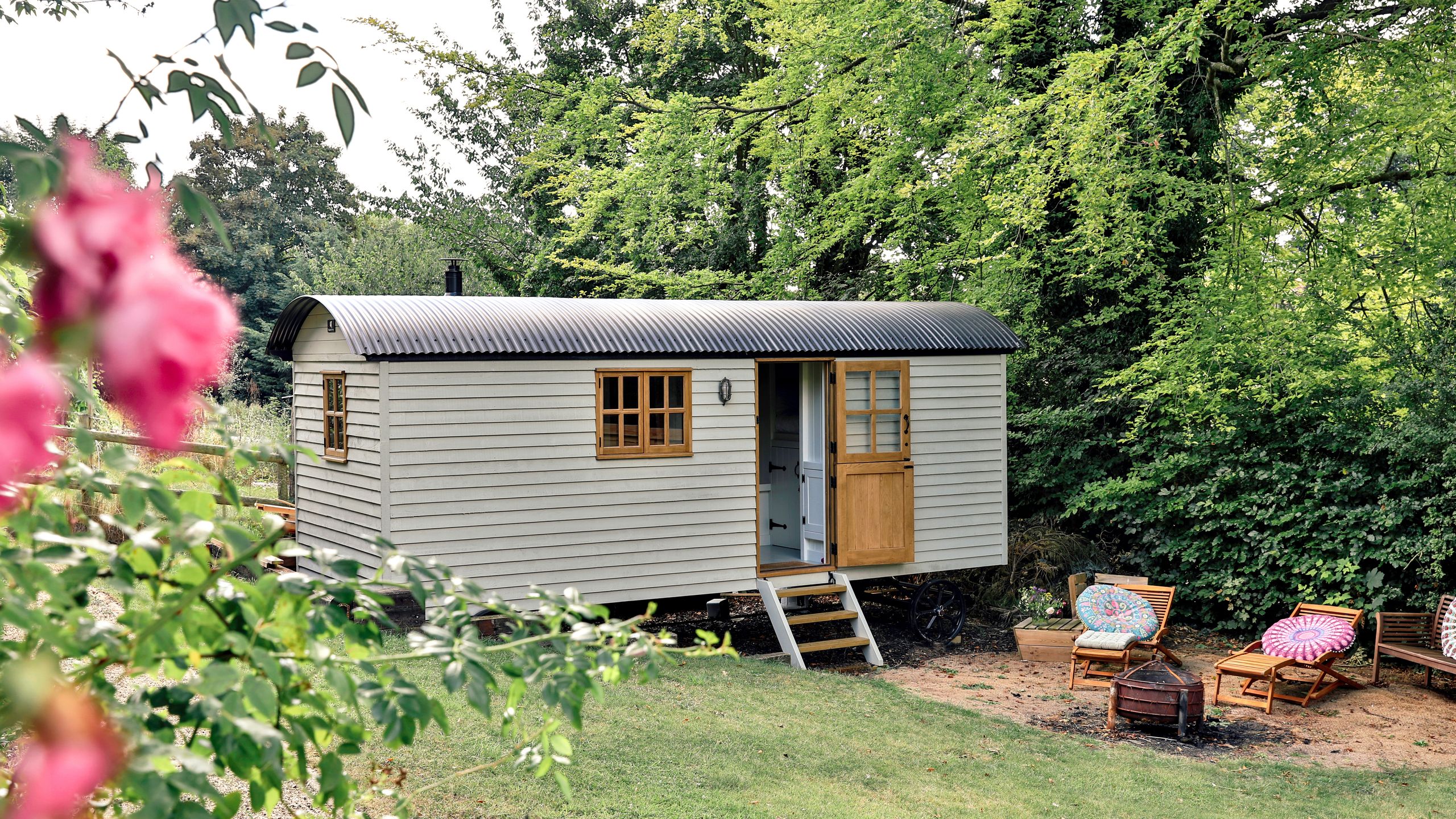 Image may contain: Architecture, Building, Housing, Chair, Furniture, House, Bench, Plant, Cabin, and Cabin In The Woods