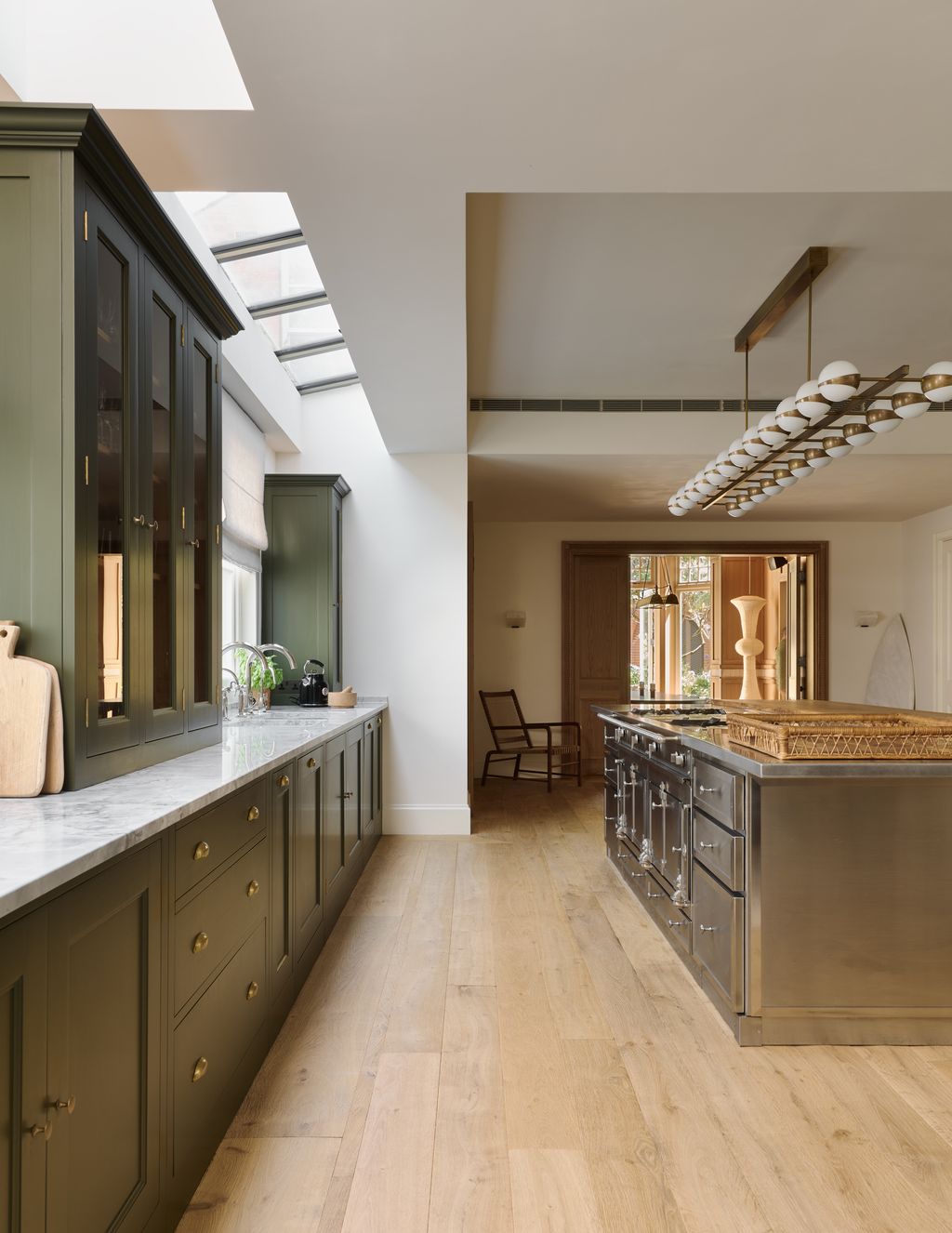 Image may contain Indoors Interior Design Floor Flooring Kitchen Chair Furniture Wood Sink and Sink Faucet