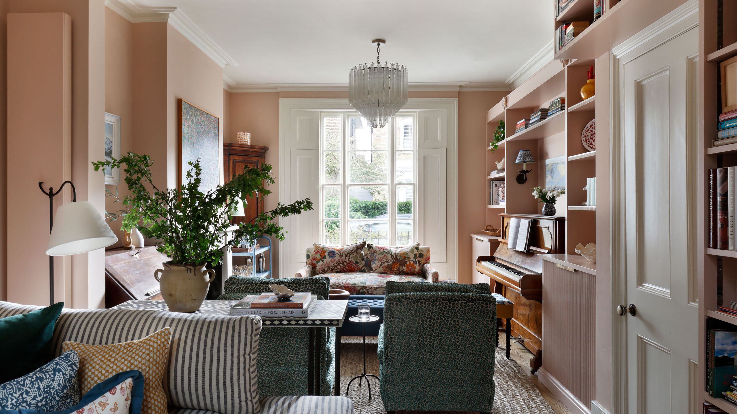 Image may contain: Home Decor, Lamp, Plant, Couch, Furniture, Keyboard, Musical Instrument, Piano, Cup, and Architecture