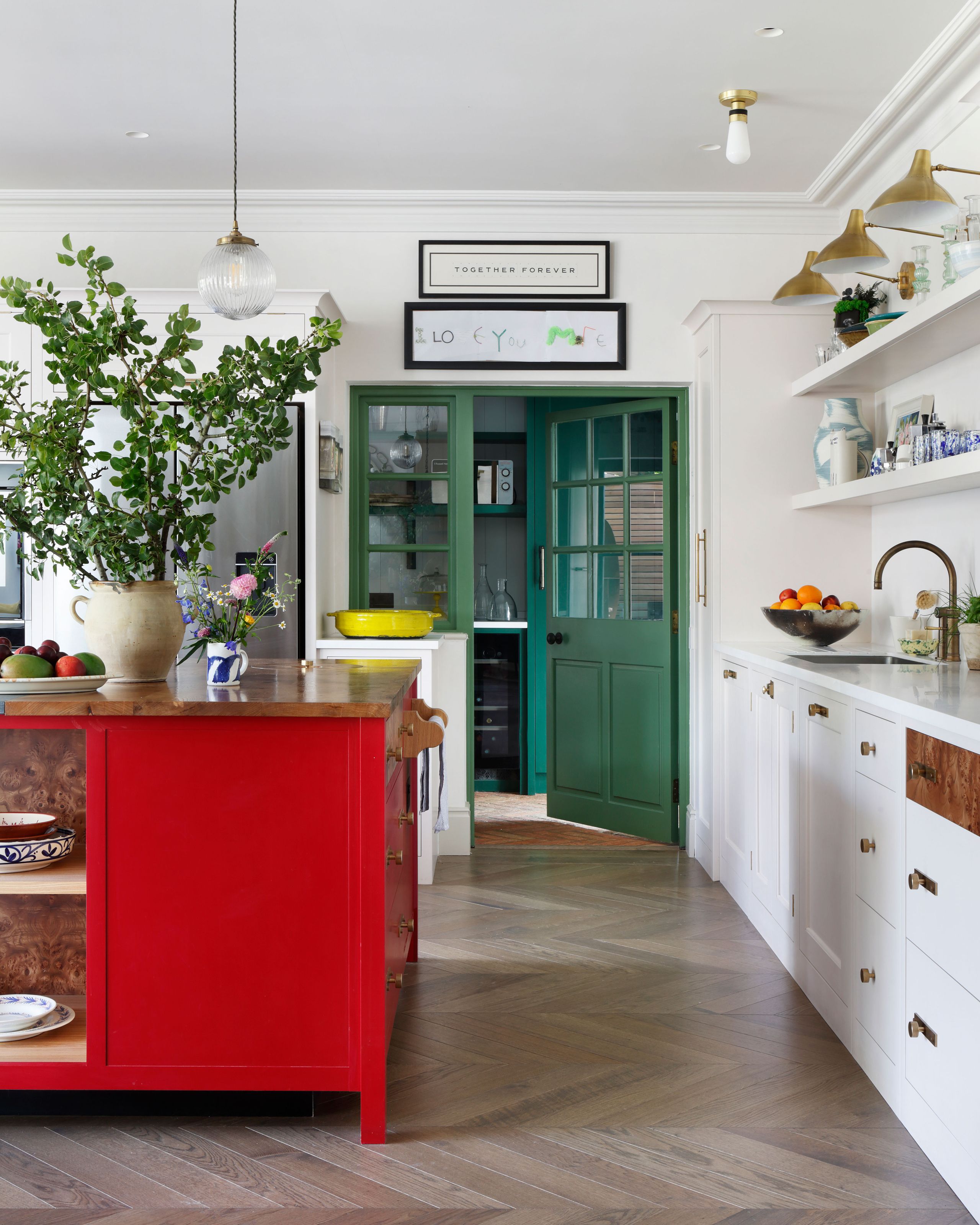 Image may contain: Indoors, Interior Design, Kitchen, Plant, Sink, Sink Faucet, Plate, Floor, Shelf, Lamp, and Cabinet