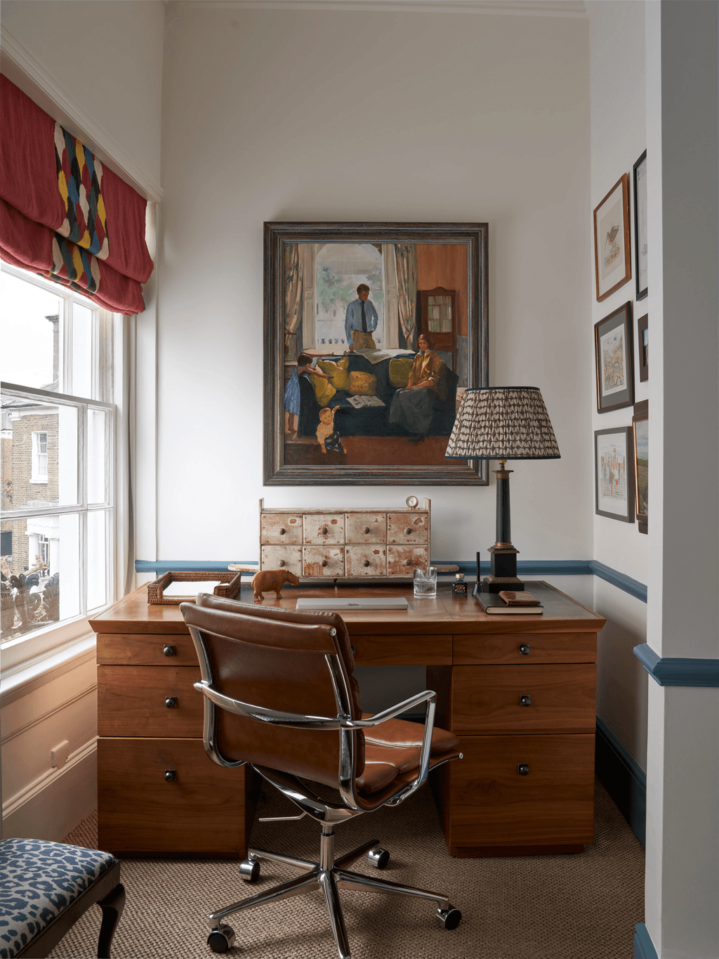 Image may contain Indoors Interior Design Chair Furniture Table Desk Person and Lamp