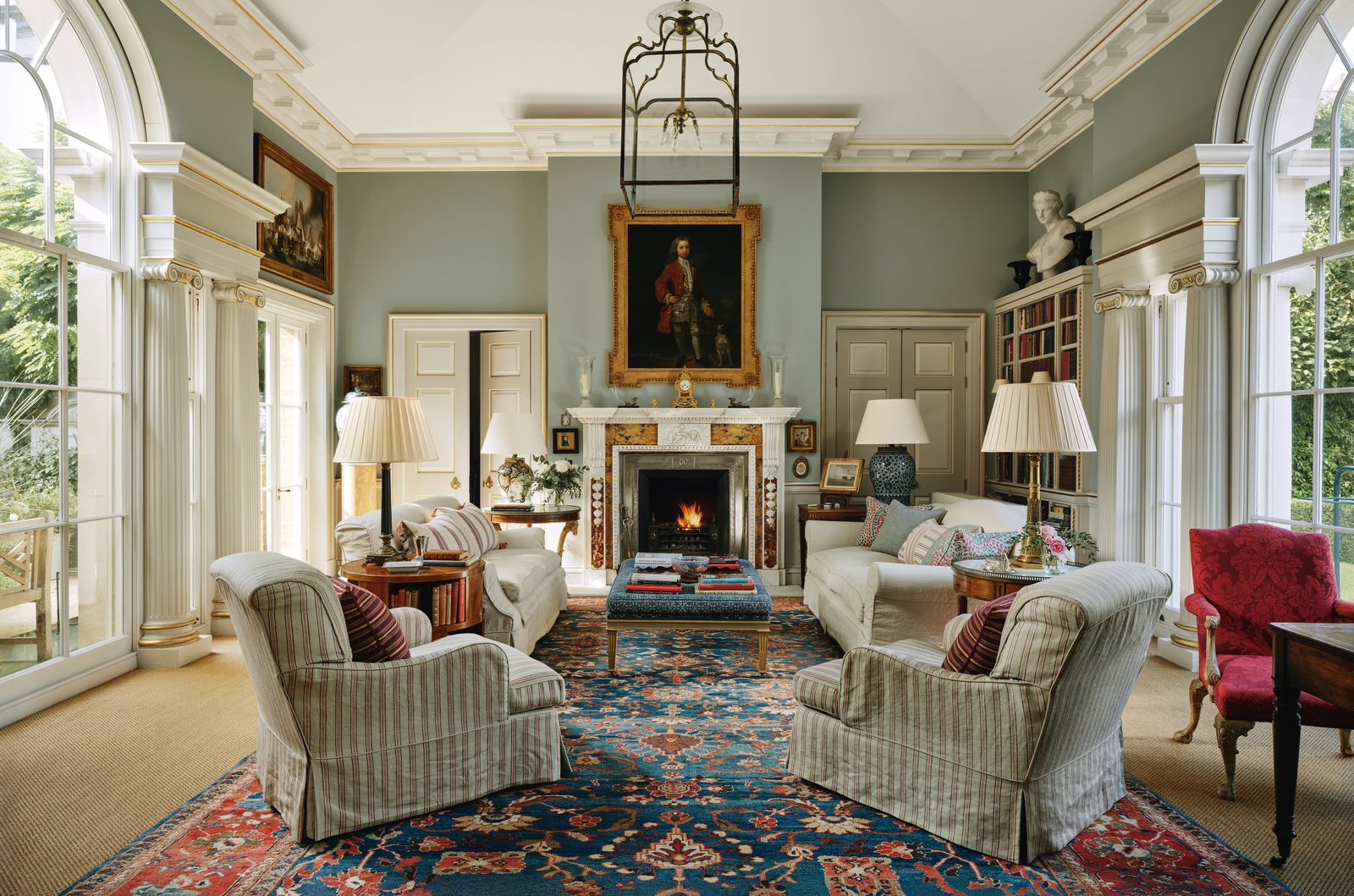 Image may contain Home Decor Architecture Building Furniture Indoors Living Room Room Lamp Fireplace Rug and Chair