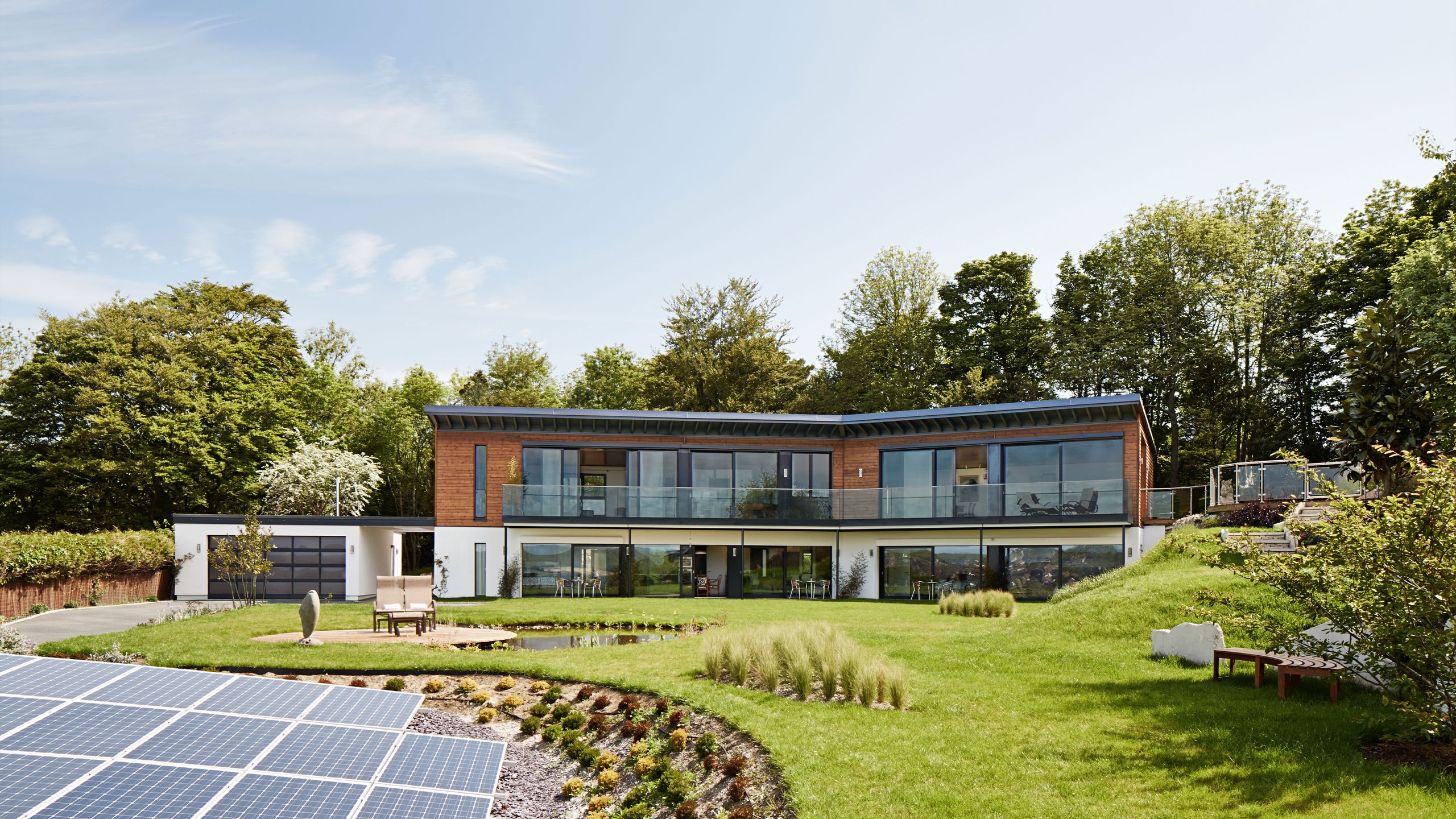 Image may contain: Outdoors, Electrical Device, Solar Panels, Bench, Furniture, Grass, and Plant