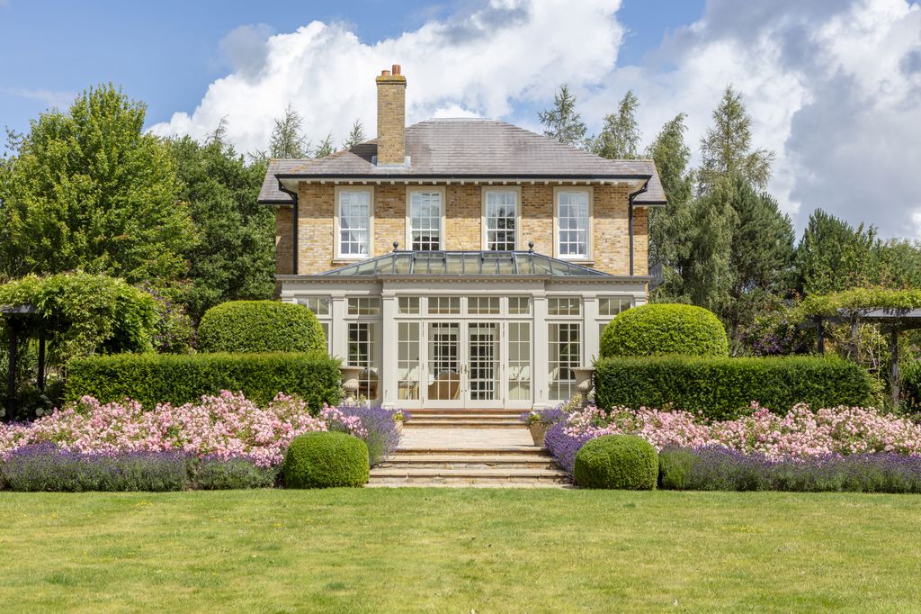 Image may contain Grass Plant Architecture Building Housing House Manor Fence Hedge and Outdoors