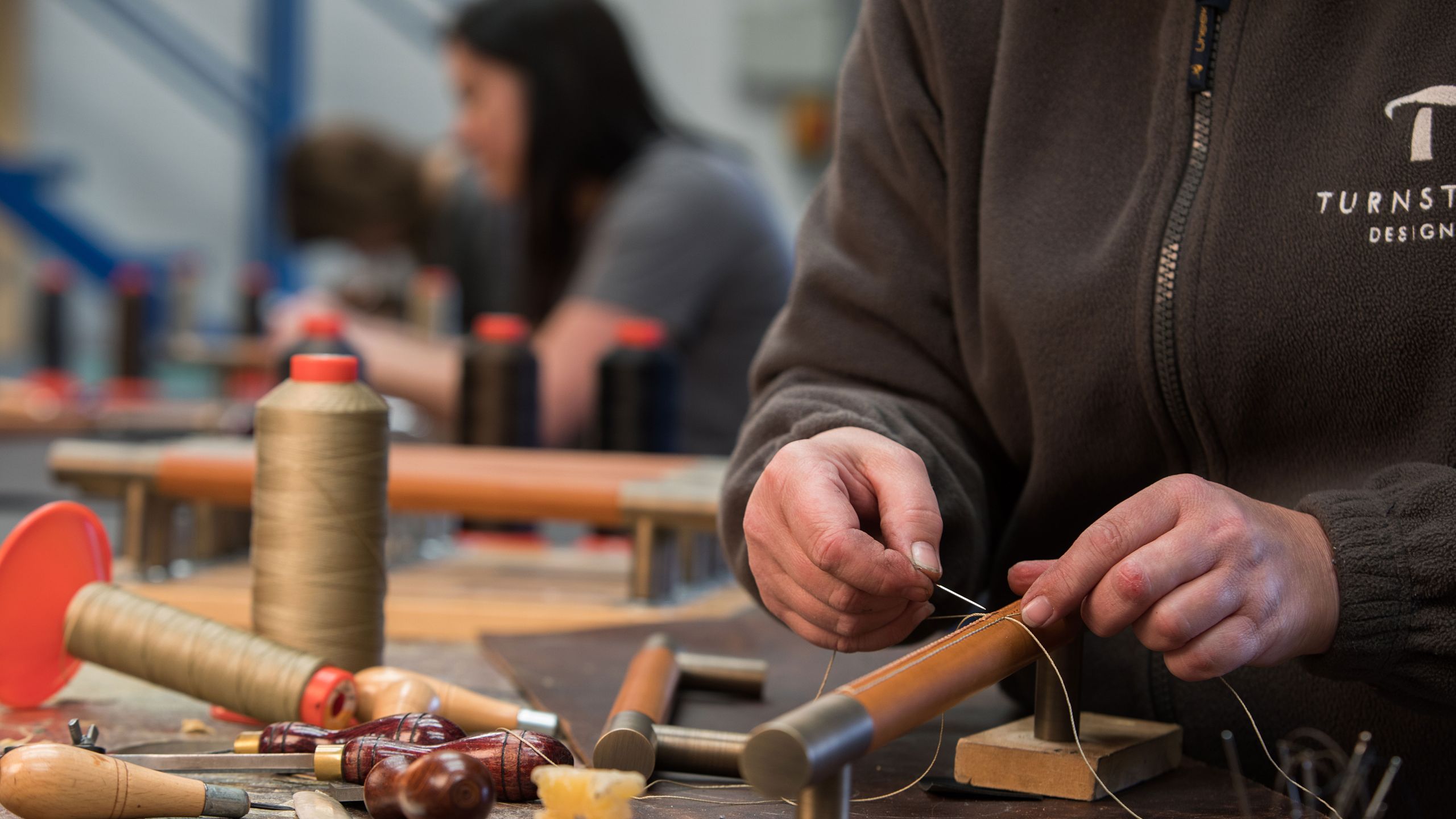 Image may contain: Adult, Person, Bench, Furniture, Mortar Shell, and Weapon