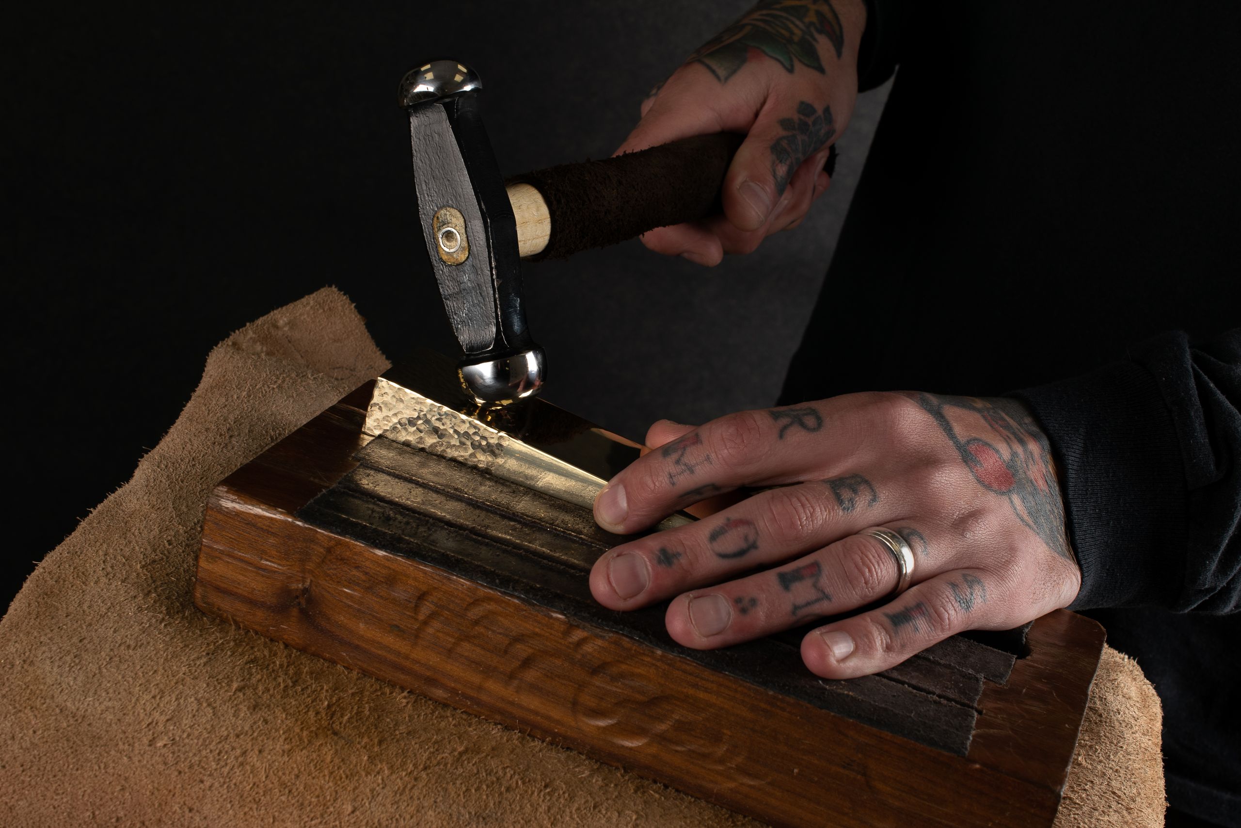 Image may contain: Body Part, Finger, Hand, Person, Accessories, Jewelry, Ring, Adult, Device, Hammer, and Tool