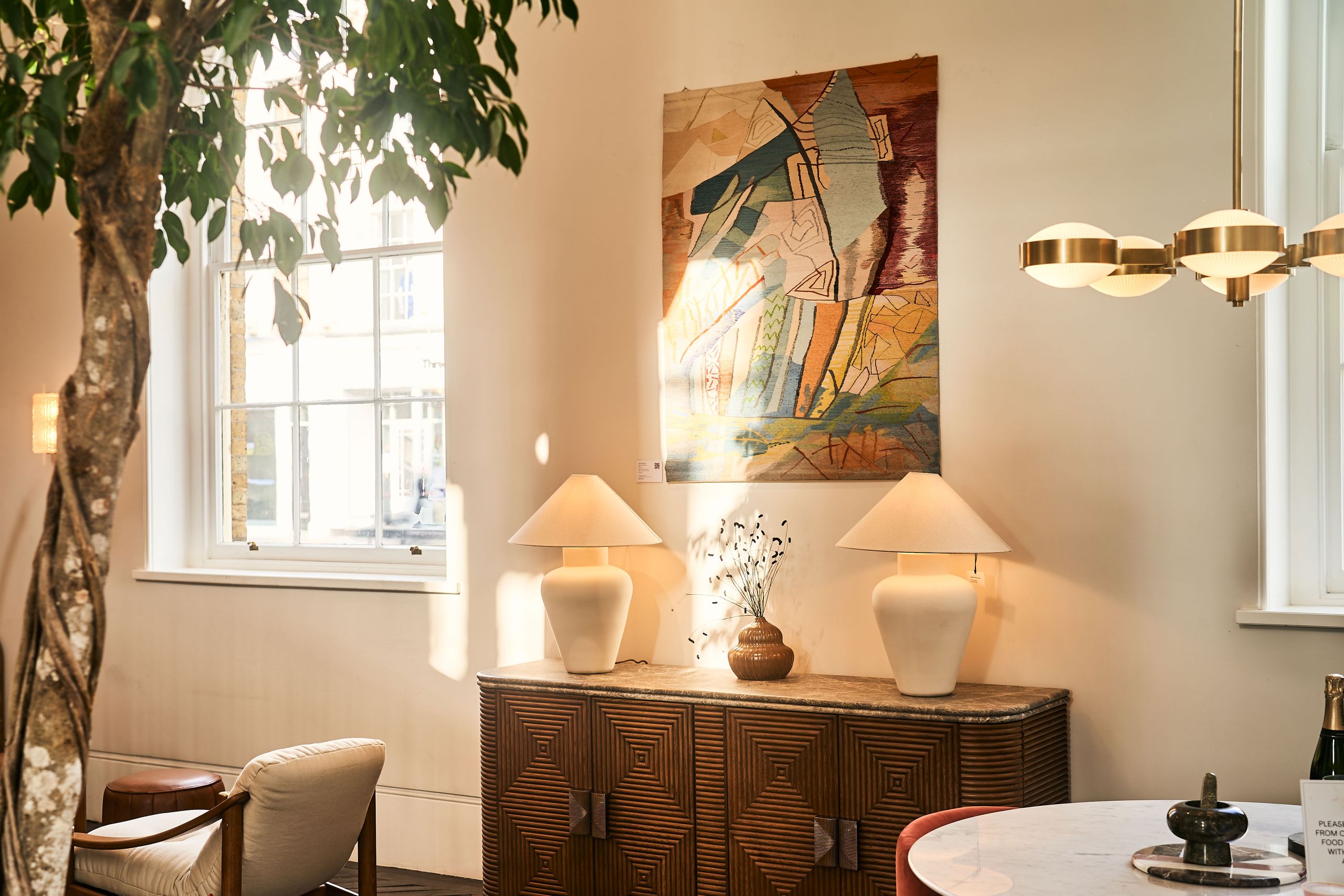 Image may contain: Lamp, Indoors, Interior Design, Chair, Furniture, Table Lamp, Desk, Table, Home Decor, and Chandelier