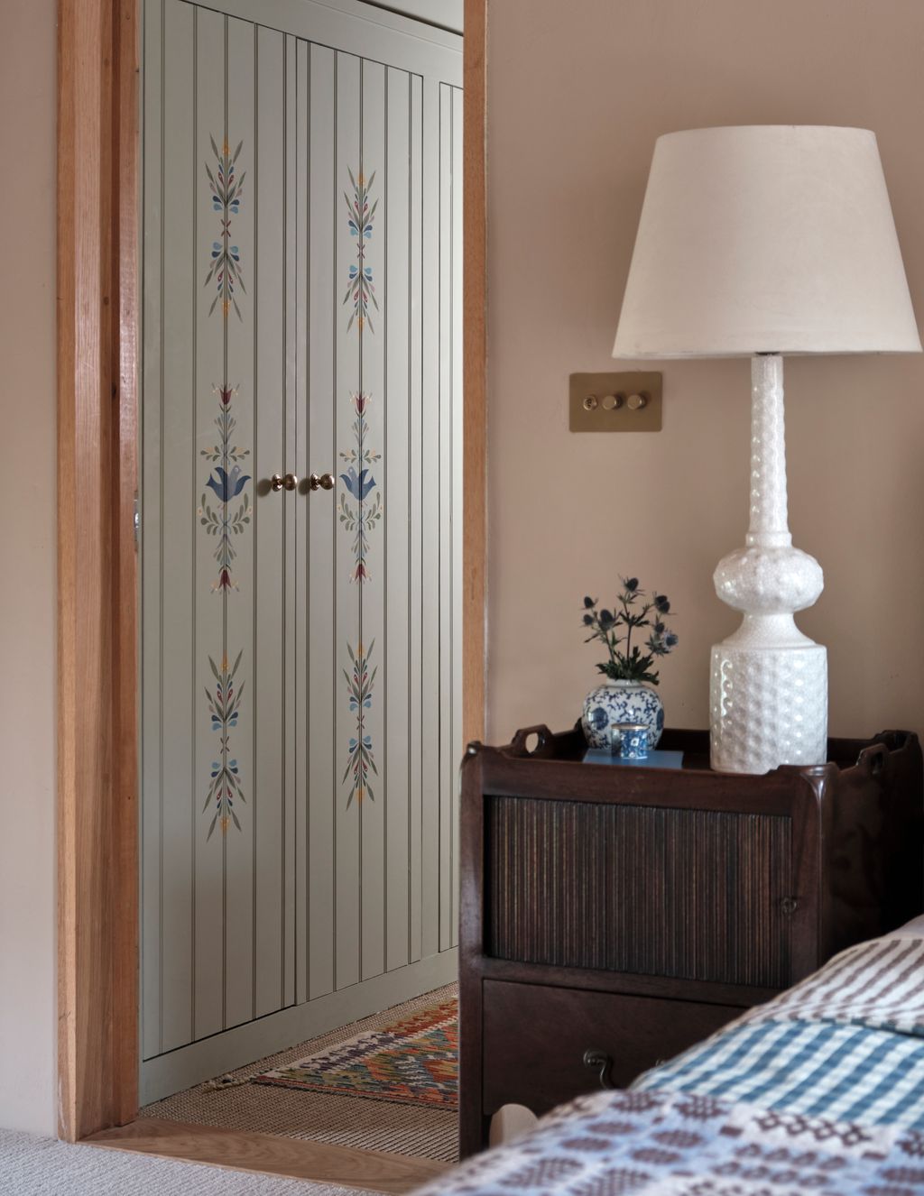 Image may contain Indoors Interior Design Lamp Table Lamp Bed Furniture and Wood Panels