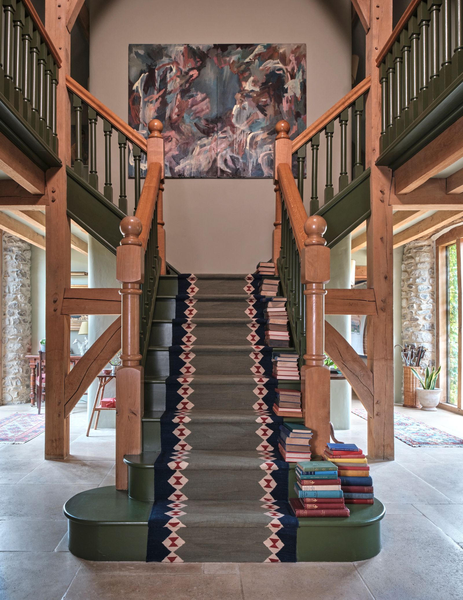 Image may contain Architecture Building House Housing Staircase Home Decor Rug Plant Foyer Indoors and Art