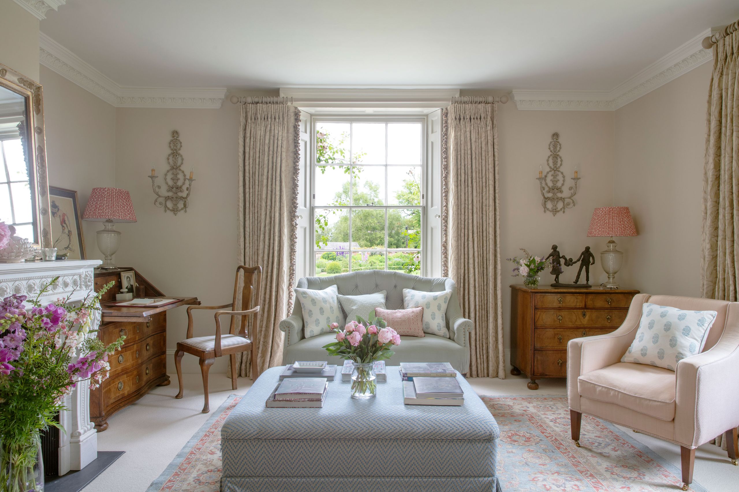 Image may contain: Lamp, Home Decor, Chair, Furniture, Book, Publication, Couch, Art, Painting, Person, Rug, and Cup