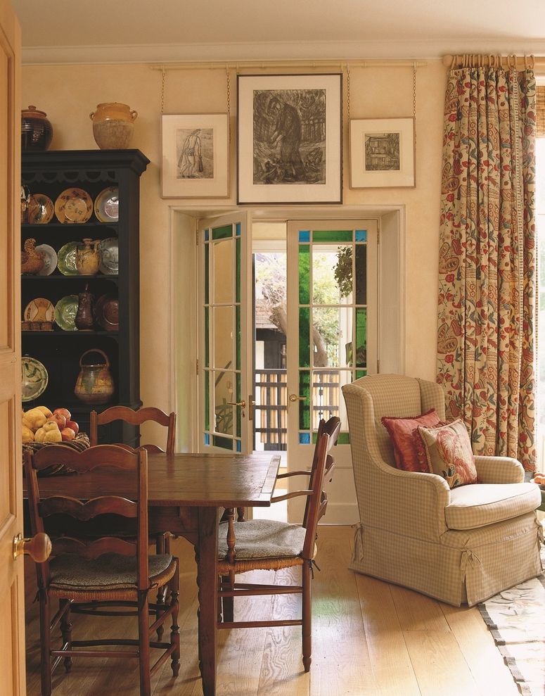 Image may contain: Door, Chair, Furniture, Art, Painting, Architecture, Building, Housing, Desk, Table, Plate, and House