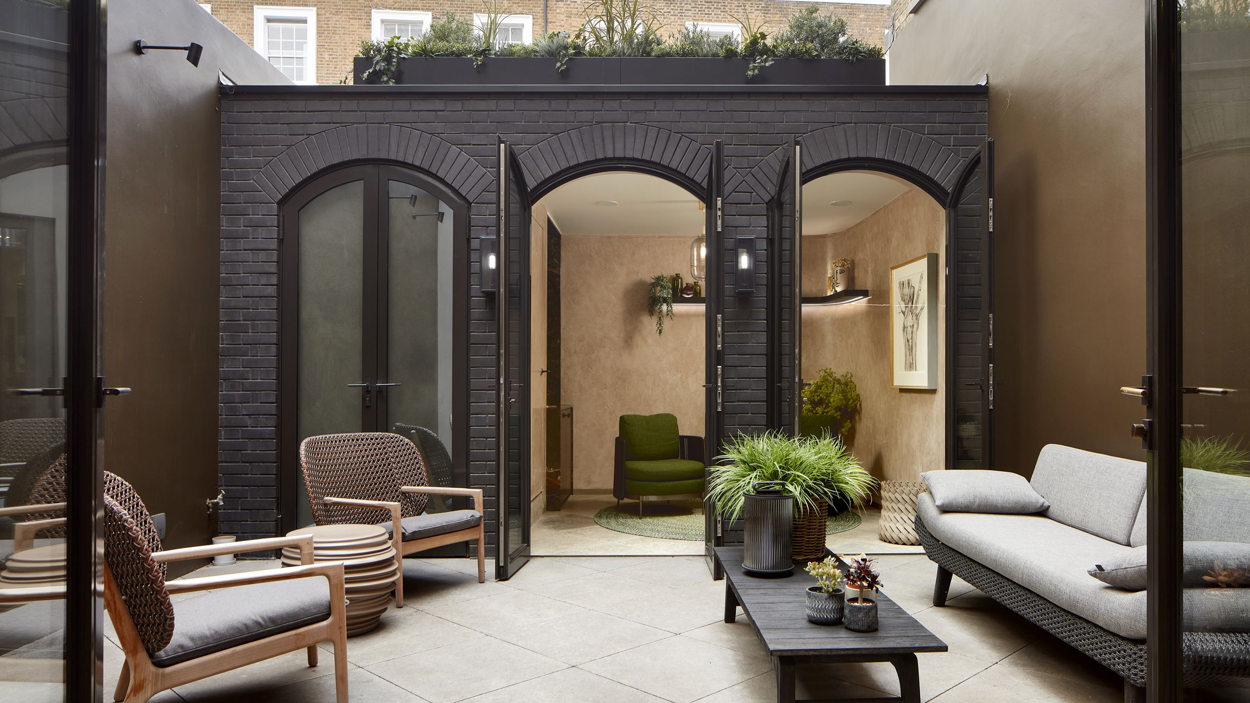 Image may contain: Door, Plant, Architecture, Building, Furniture, Indoors, Living Room, Room, Chair, Housing, and Couch