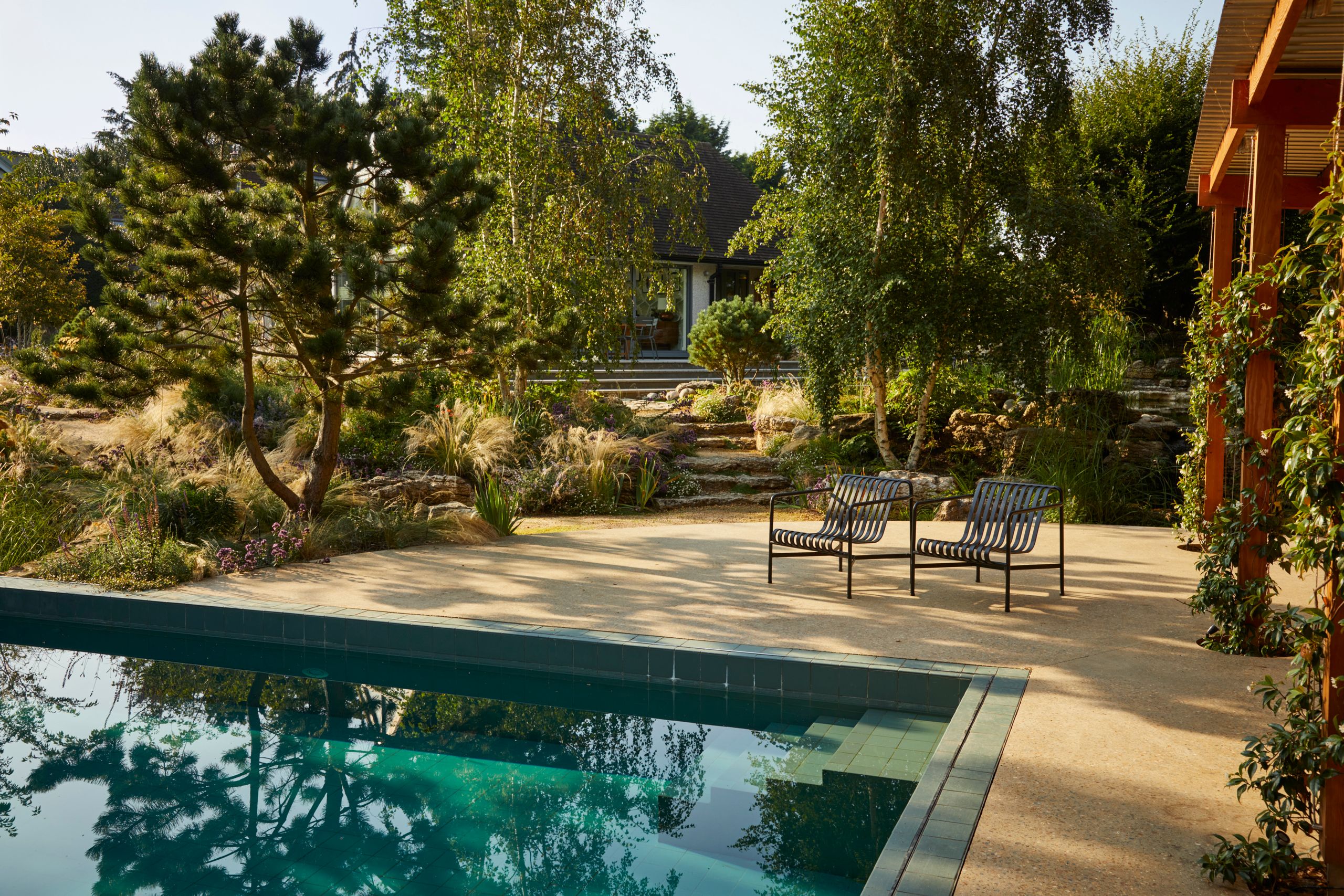 Image may contain: Backyard, Nature, Outdoors, Yard, Architecture, Building, House, Housing, Villa, Bench, and Furniture