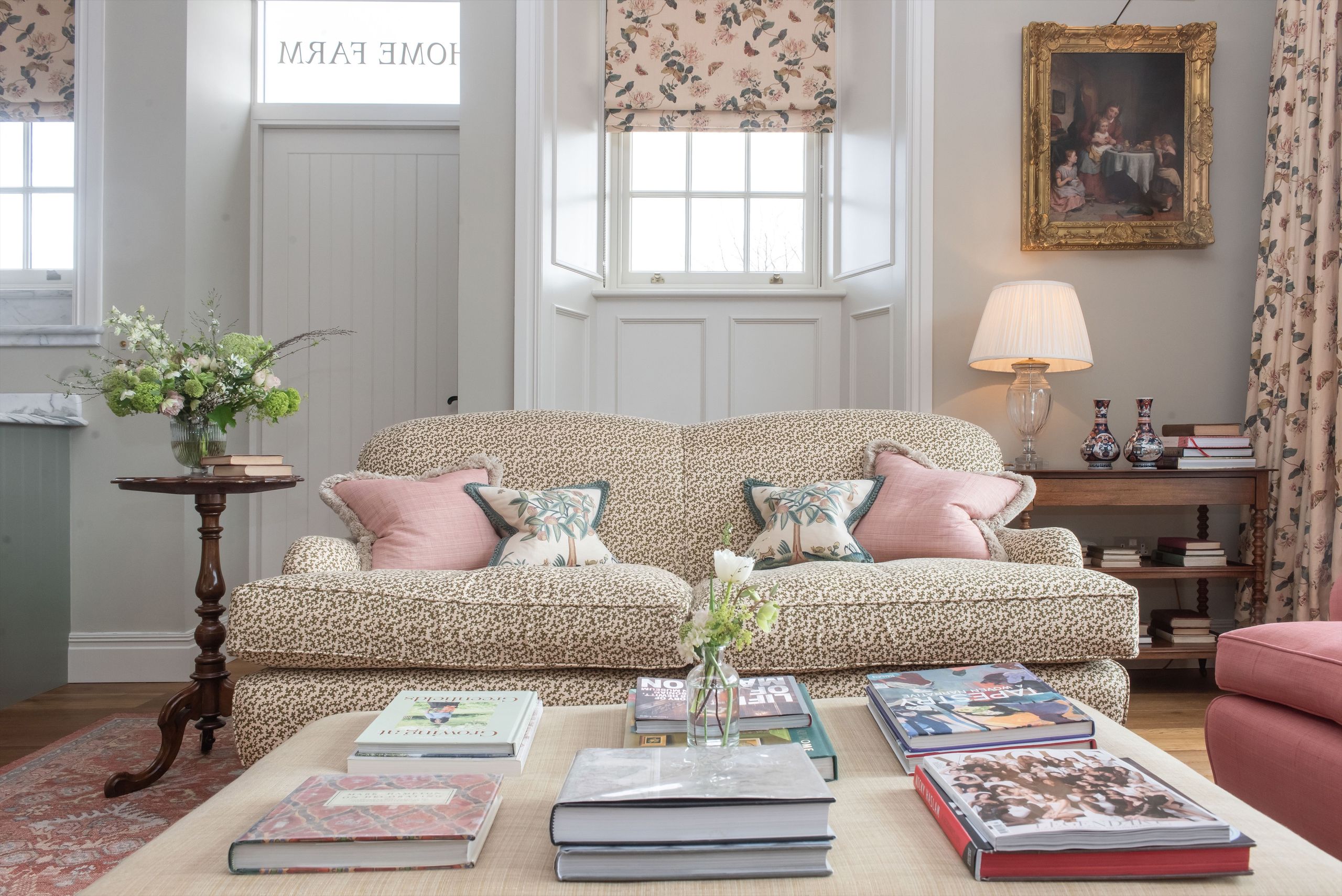 Image may contain: Home Decor, Lamp, Cushion, Book, Publication, Couch, Furniture, Table, Architecture, Building, and Indoors