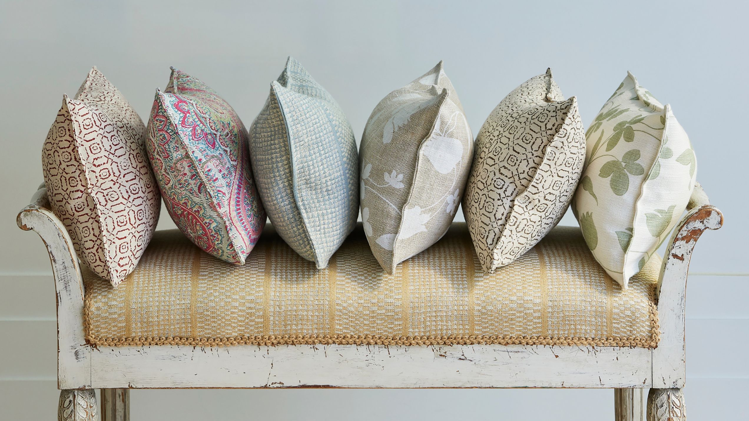 Image may contain: Cushion, Home Decor, Pillow, Bench, Furniture, and Couch