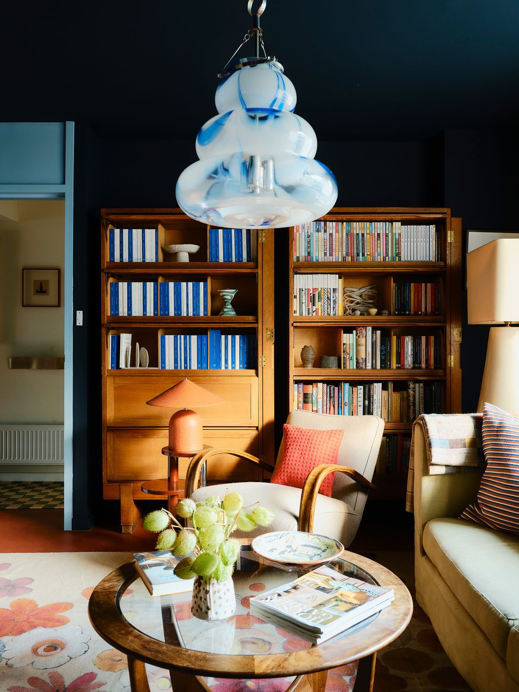 Image may contain Furniture Book Publication Art Painting Lamp Couch Chair Table Bookcase Plate and Home Decor