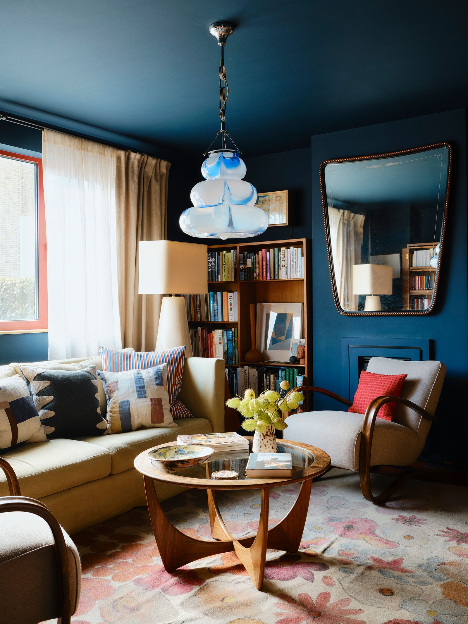 Image may contain Home Decor Architecture Building Furniture Indoors Living Room Room Lamp Table Couch and Chair