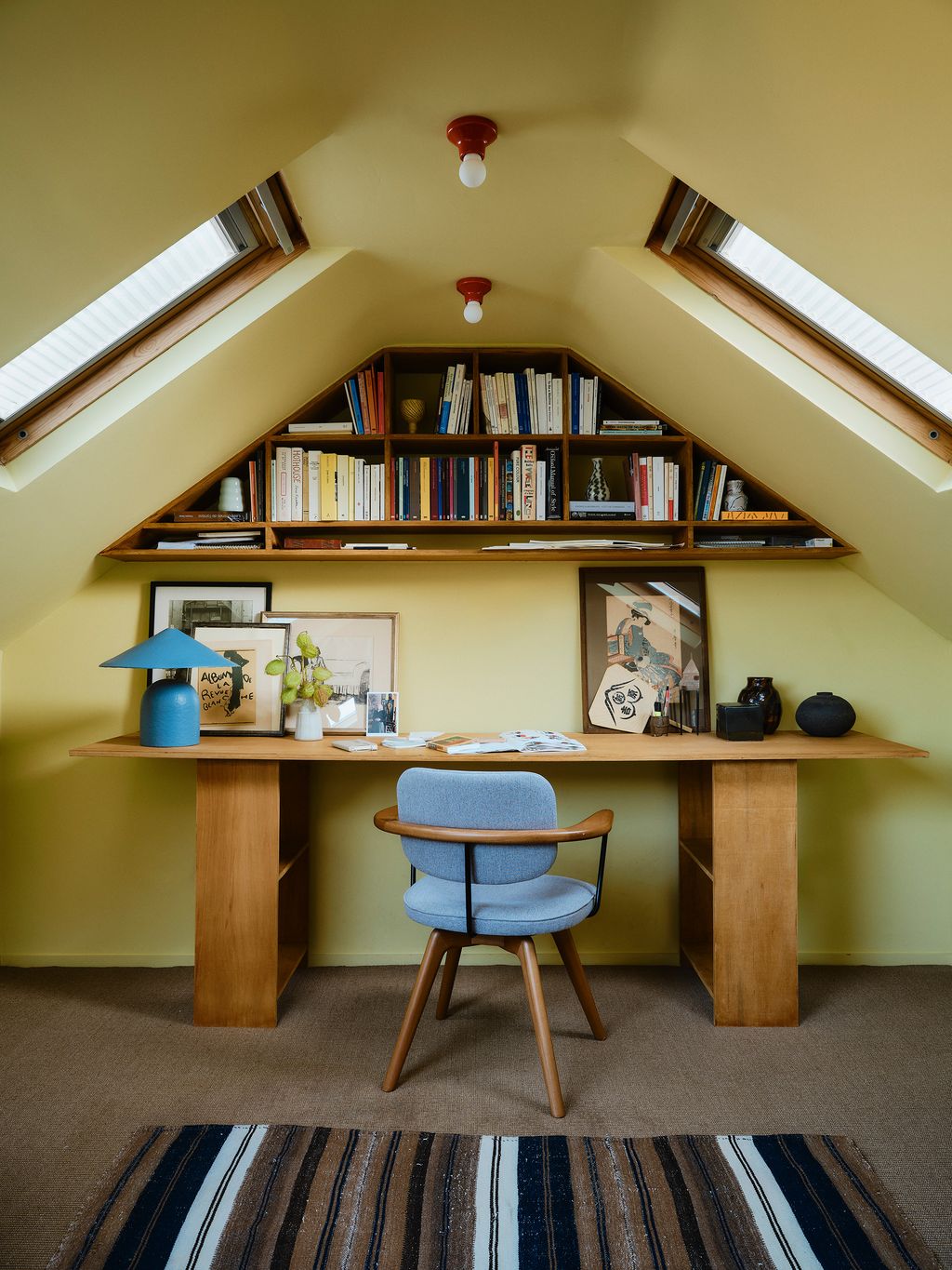 Image may contain Desk Furniture Table Chair Architecture Building House Housing Indoors Loft Room Lamp and Art