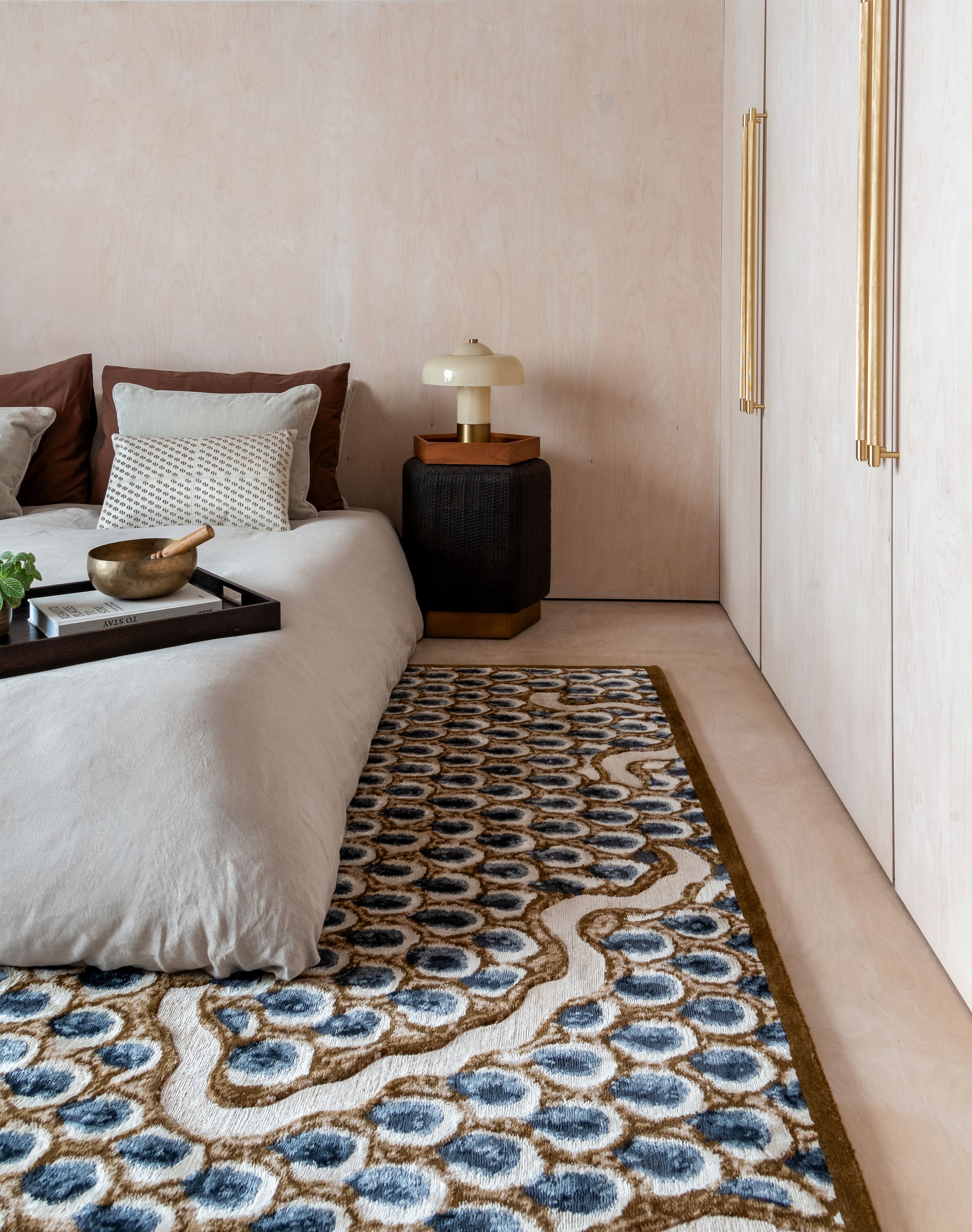 Image may contain: Home Decor, Rug, Lamp, and Plant