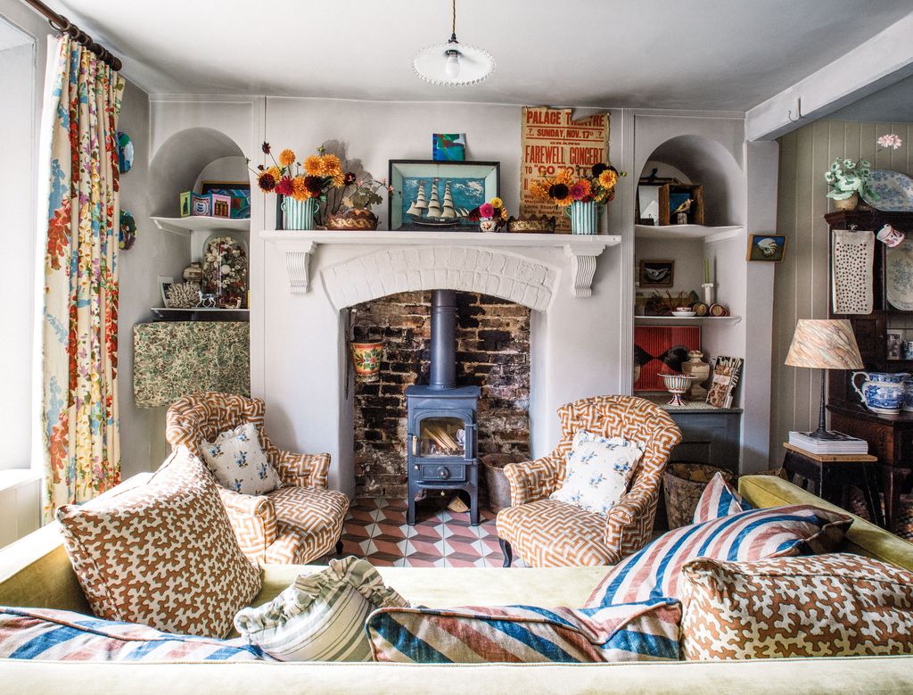 Image may contain Home Decor Cushion Lamp Chair Furniture Art Painting Fireplace Indoors and Pillow