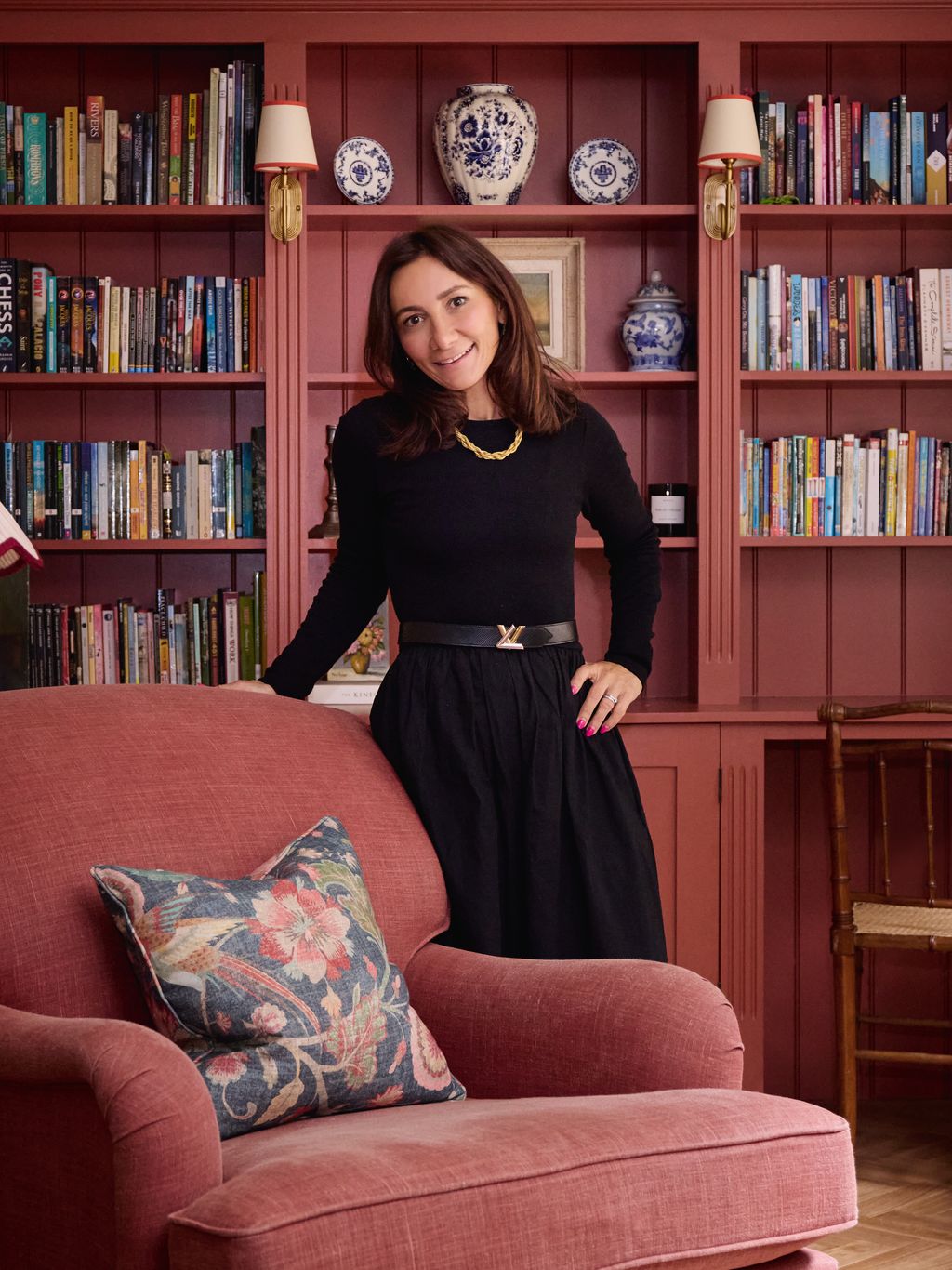 Image may contain Furniture Accessories Belt Lamp Adult Person Couch Chair Jewelry Necklace and Indoors