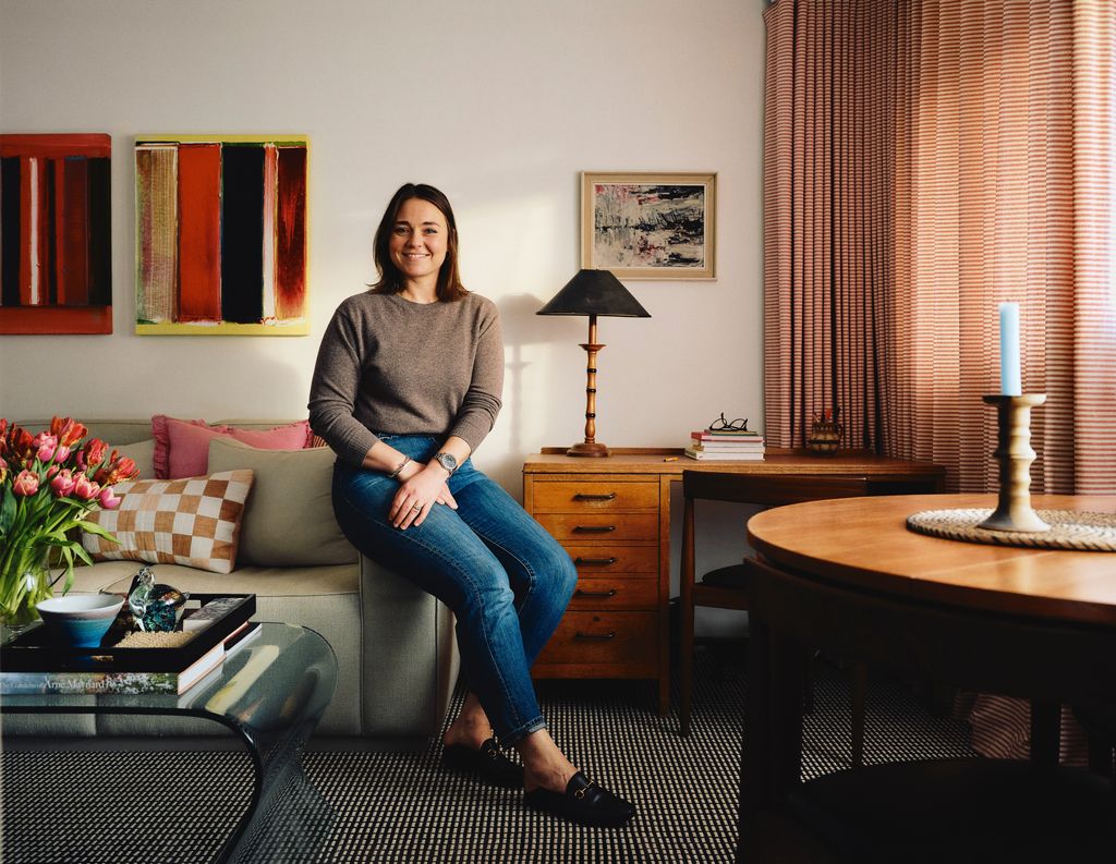 Image may contain Person Sitting Lamp Adult Clothing Footwear Shoe Pants Art Painting Wristwatch and Candle