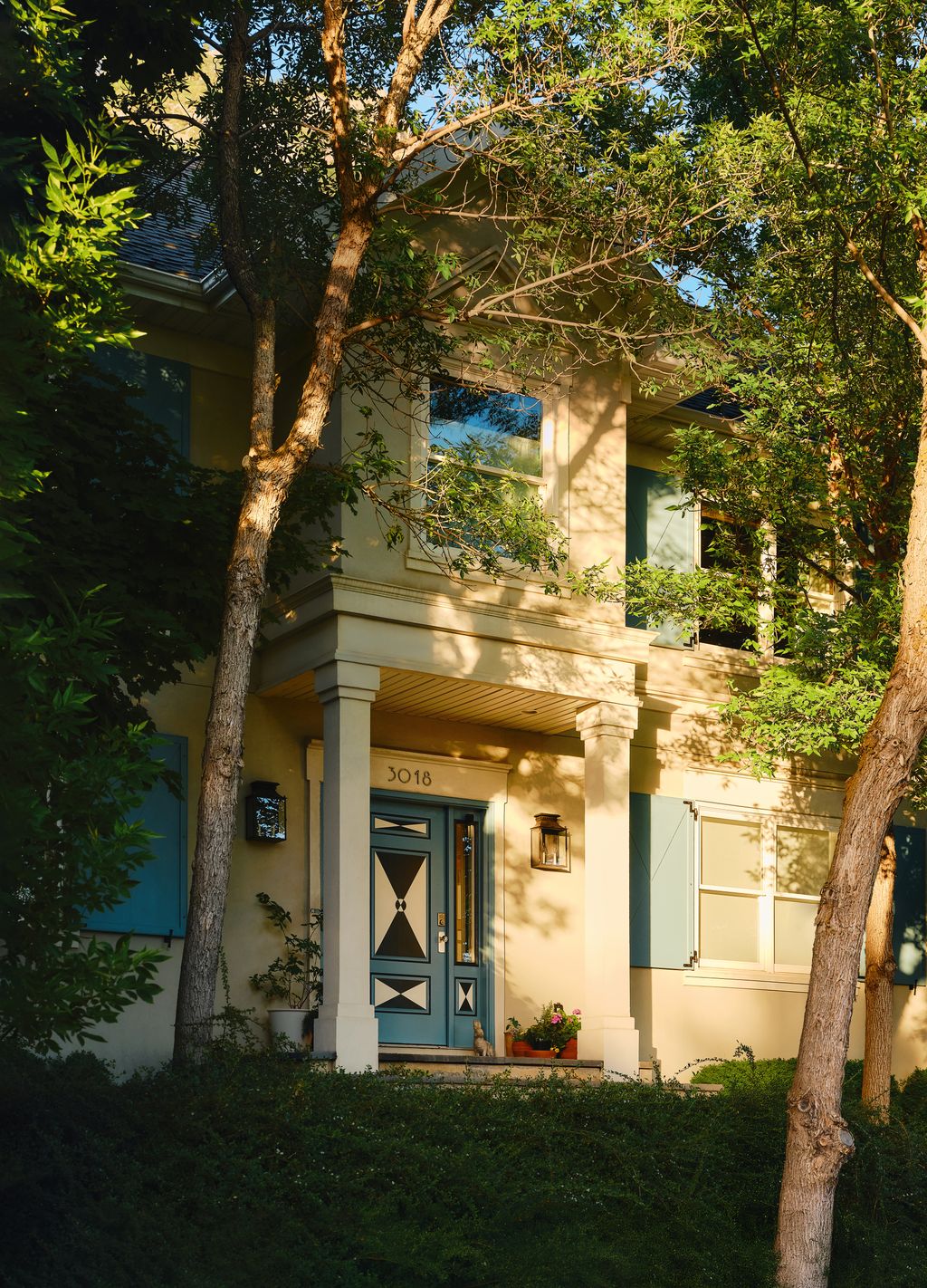 Image may contain Plant Tree Grass Lamp Vegetation Door Architecture Building Housing House Villa and Portico