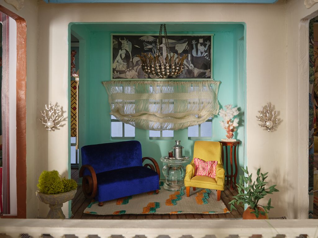 Image may contain Architecture Building Furniture Indoors Living Room Room Plant Home Decor Chair Rug and Couch