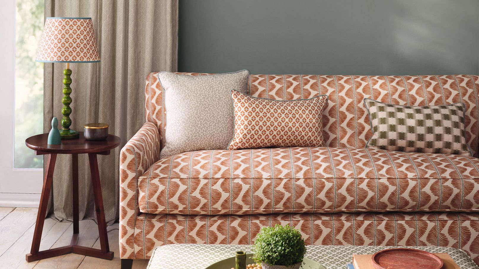 Image may contain: Cushion, Home Decor, Couch, Furniture, Lamp, Plant, Pillow, Desk, Table, Architecture, and Building