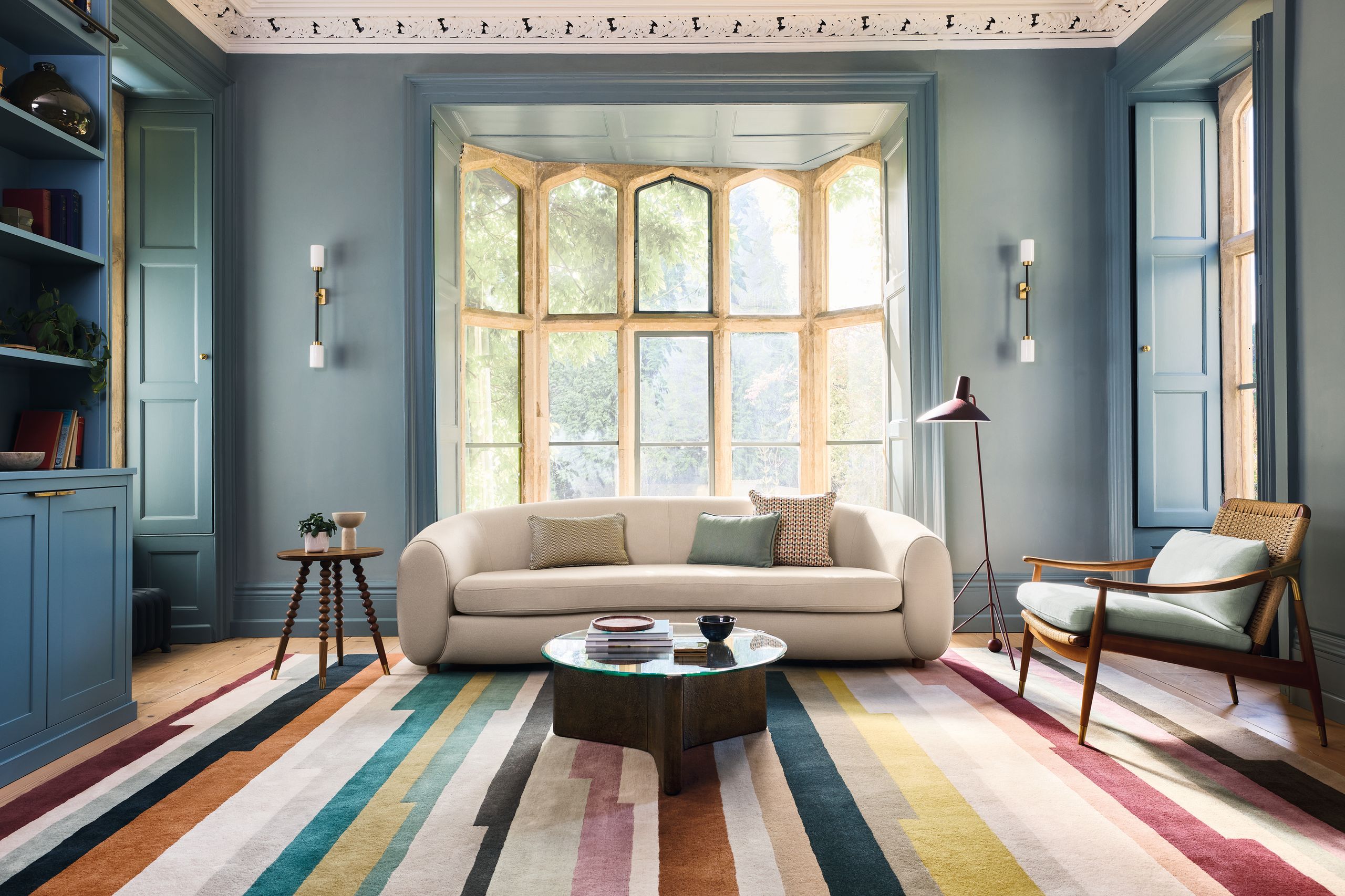 Image may contain: Home Decor, Lamp, Couch, Furniture, Plant, Chair, Rug, Window, Coffee Table, Table, Bay Window, and Desk