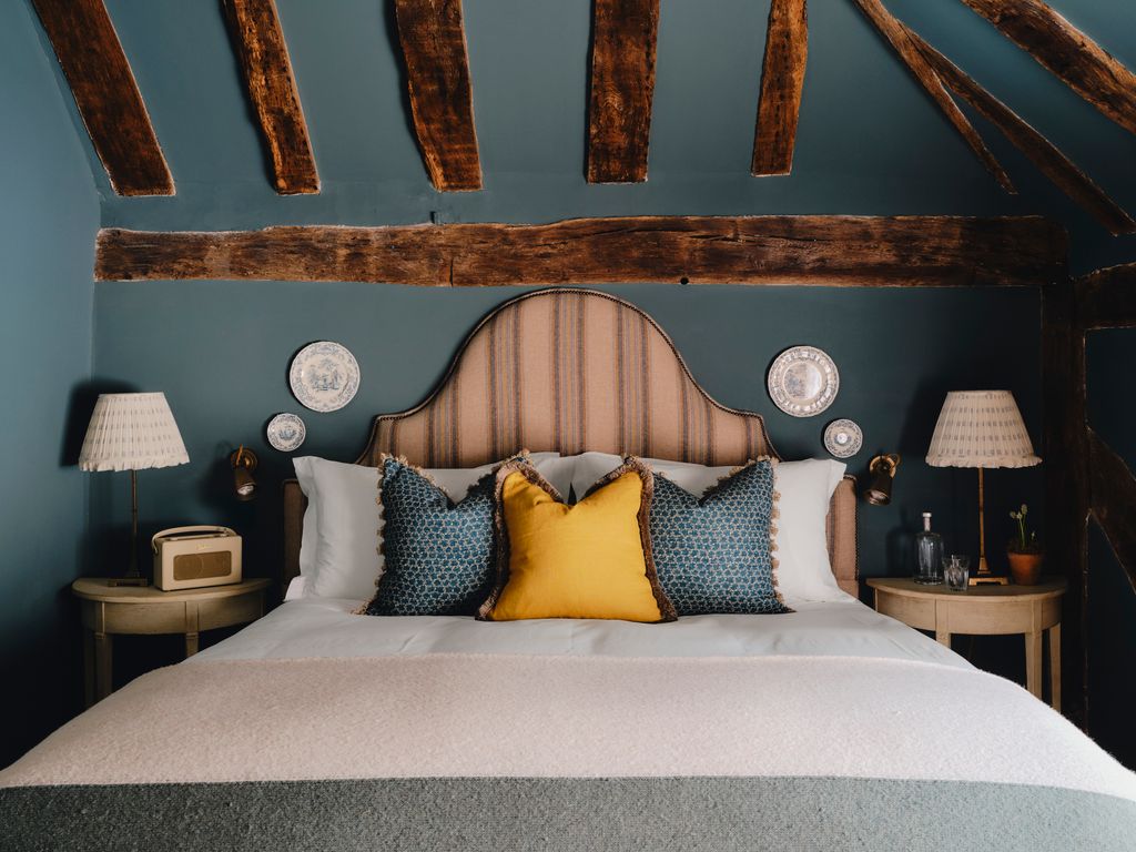 Image may contain Cushion Home Decor Indoors Interior Design Pillow Lamp Bed Furniture Plant Cup Desk and Table