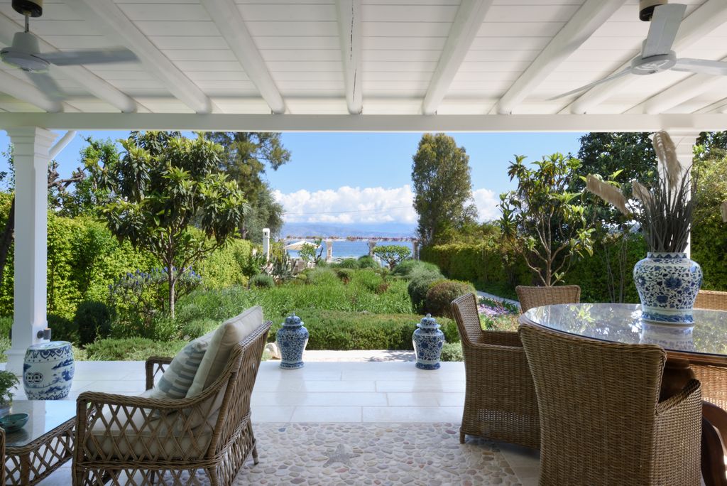 Image may contain Chair Furniture Terrace Plant Architecture Building House Housing Porch Home Decor and Rug