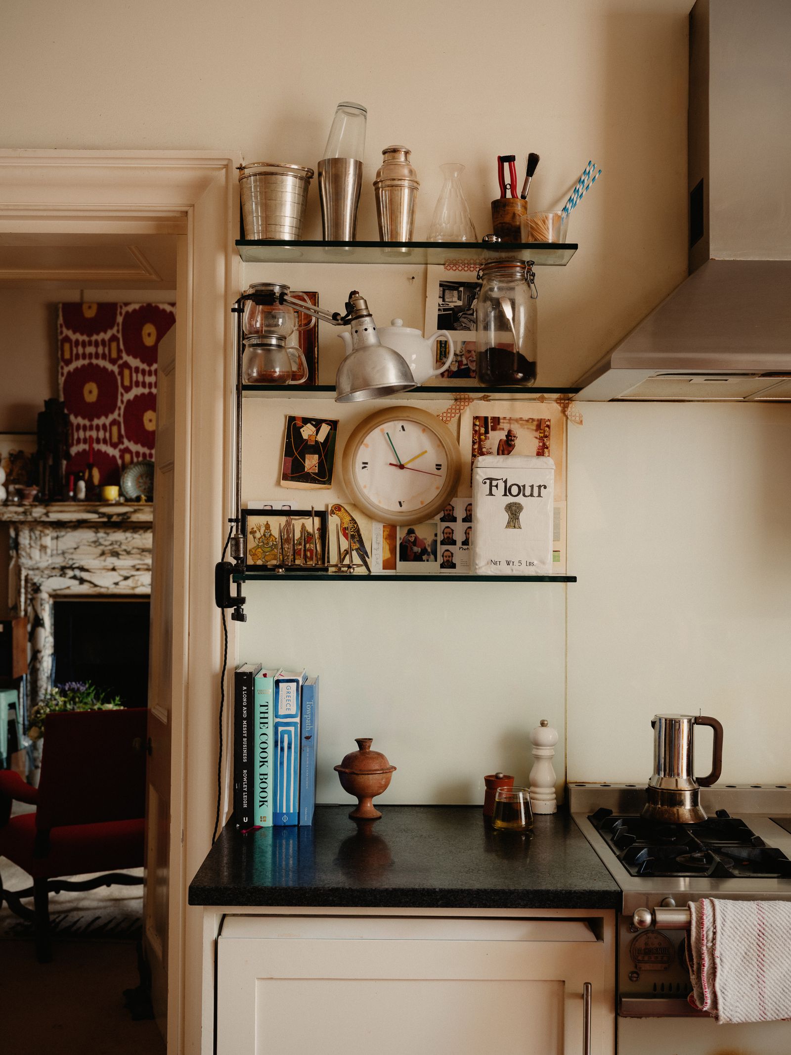 Image may contain Shelf Indoors Interior Design Chair Furniture Cooktop Kitchen Person Cup and Bookcase