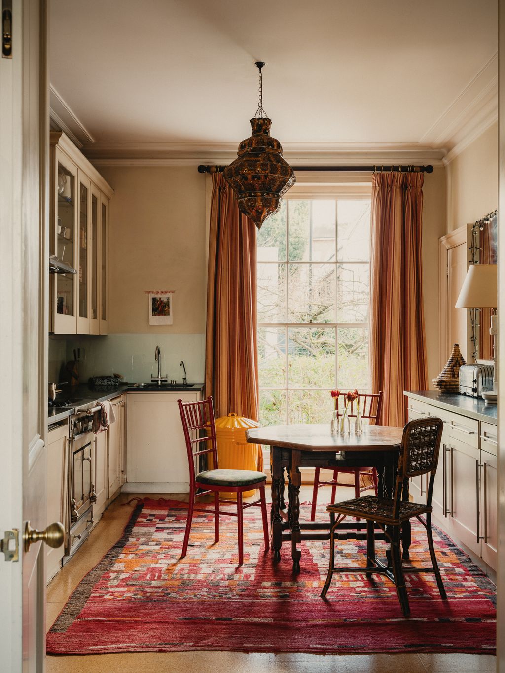 Image may contain Home Decor Rug Lamp Chair Furniture Architecture Building Dining Room Dining Table and Indoors