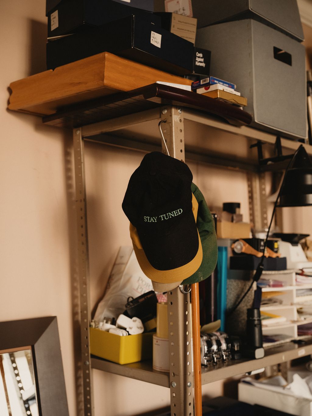 Image may contain Baseball Cap Cap Clothing Hat Shelf Furniture Desk and Table