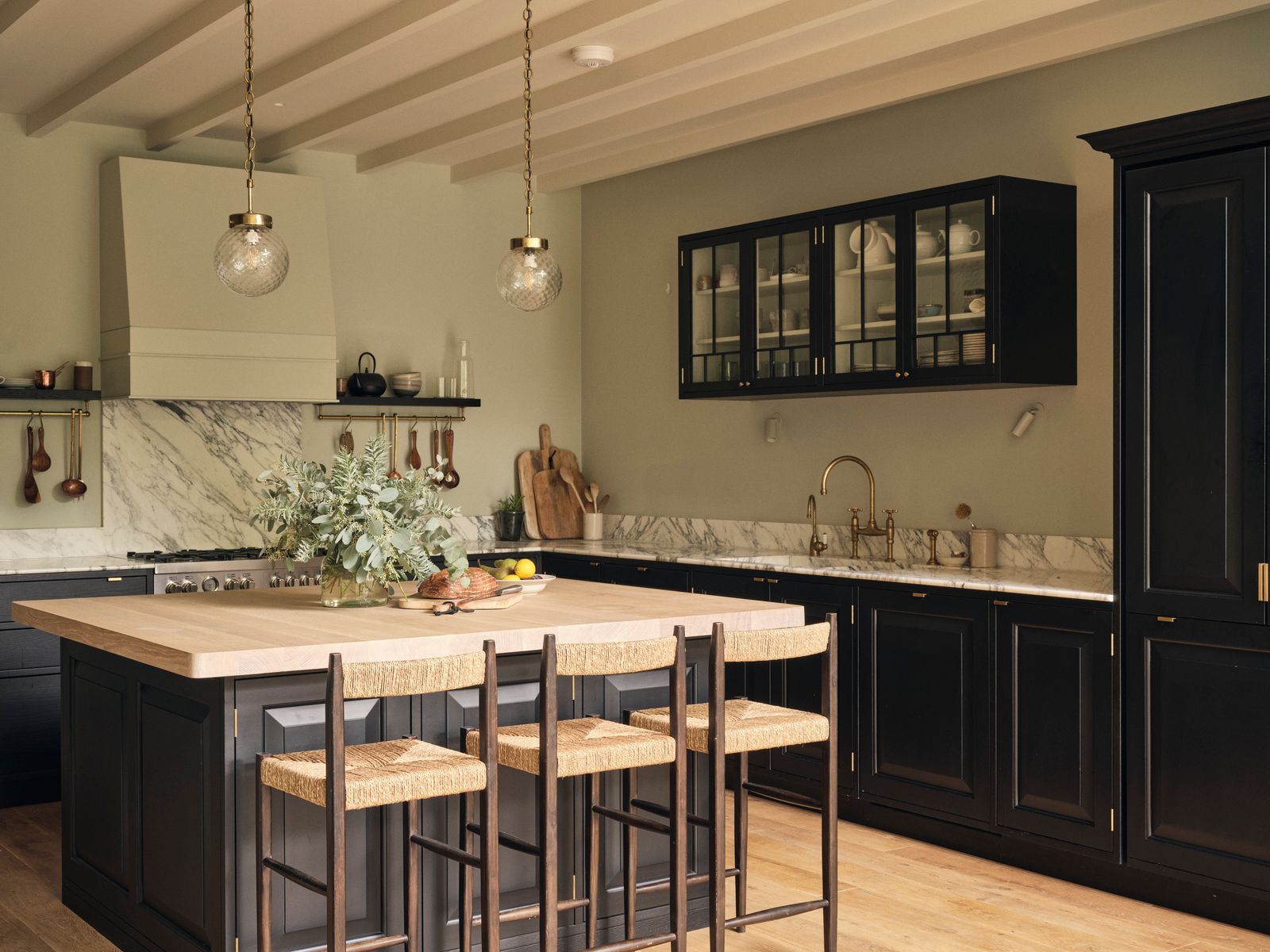 Image may contain Indoors Kitchen Interior Design Kitchen Island Sink Sink Faucet Bread Food Plant and Furniture