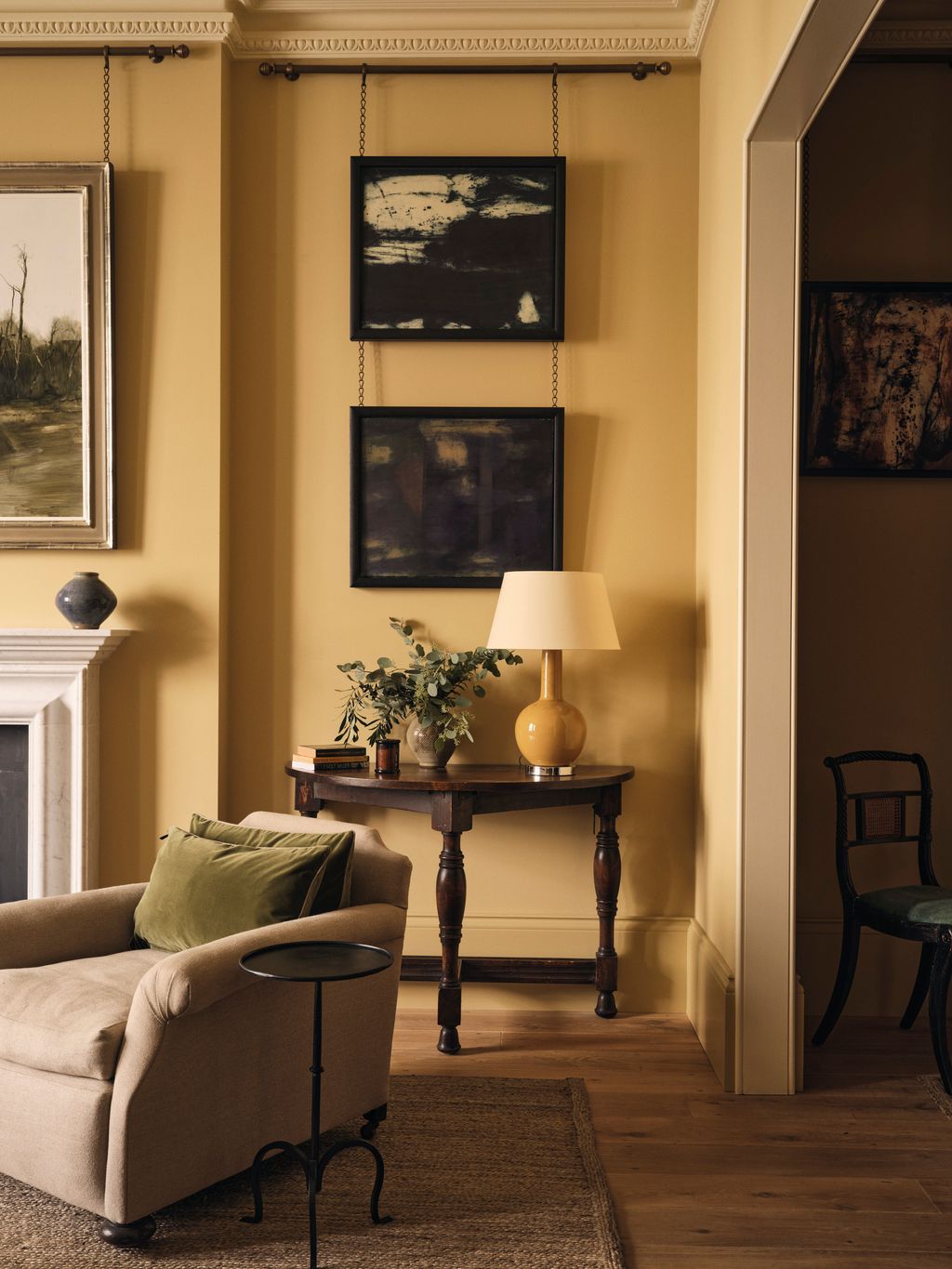 Image may contain Lamp Desk Furniture Table Art Painting Indoors Interior Design Plant Home Decor and Rug