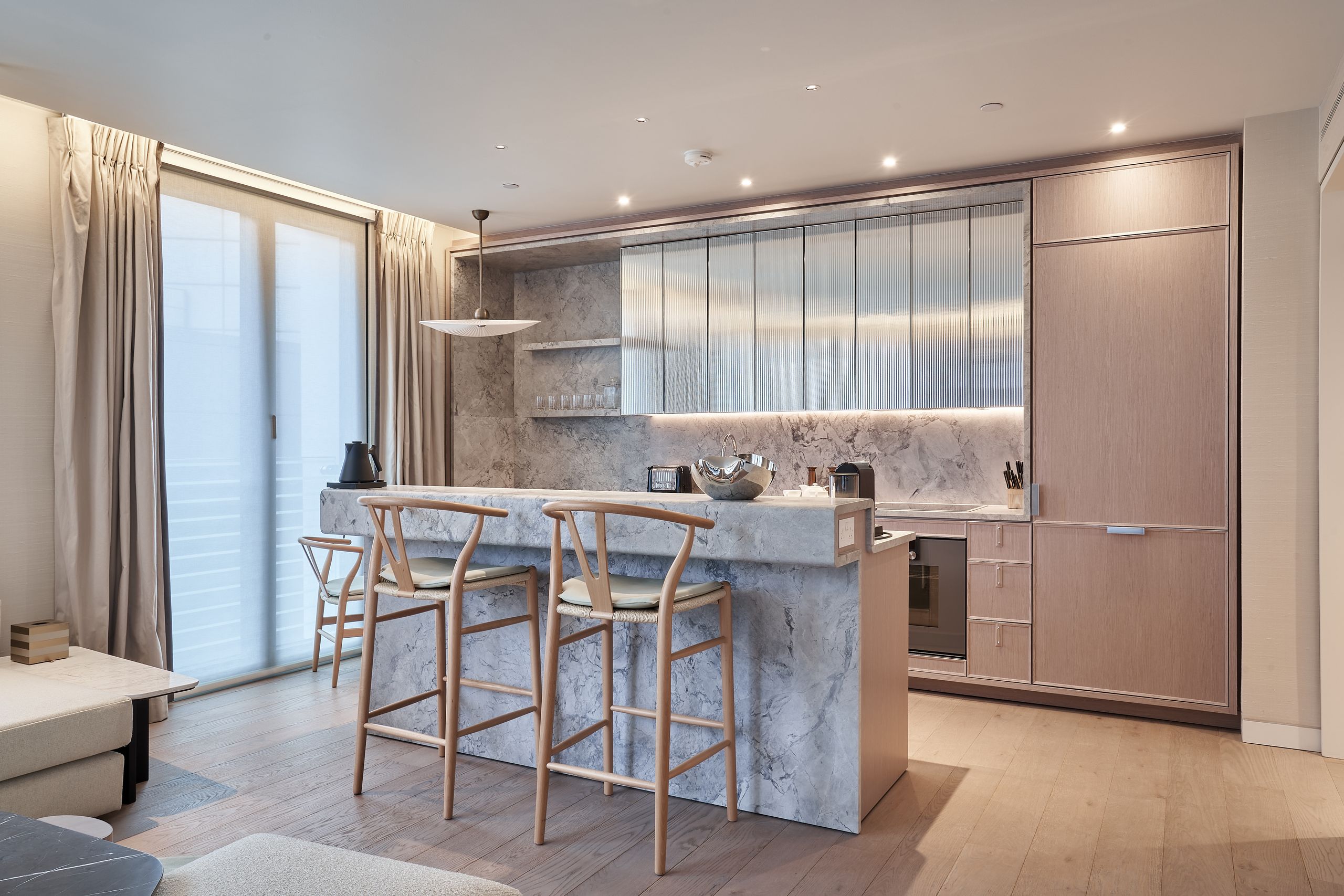 Image may contain: Indoors, Interior Design, Chair, Furniture, Lamp, Kitchen, Home Decor, Desk, Table, and Kitchen Island