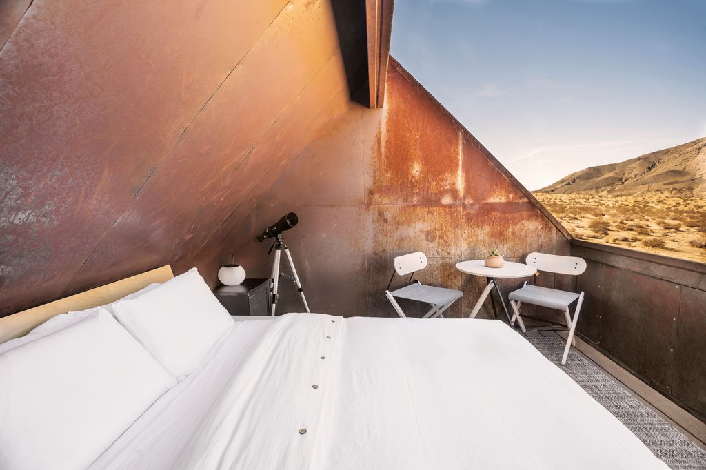 Image may contain Chair Furniture Desk Table Plant Bed Electrical Device and Microphone