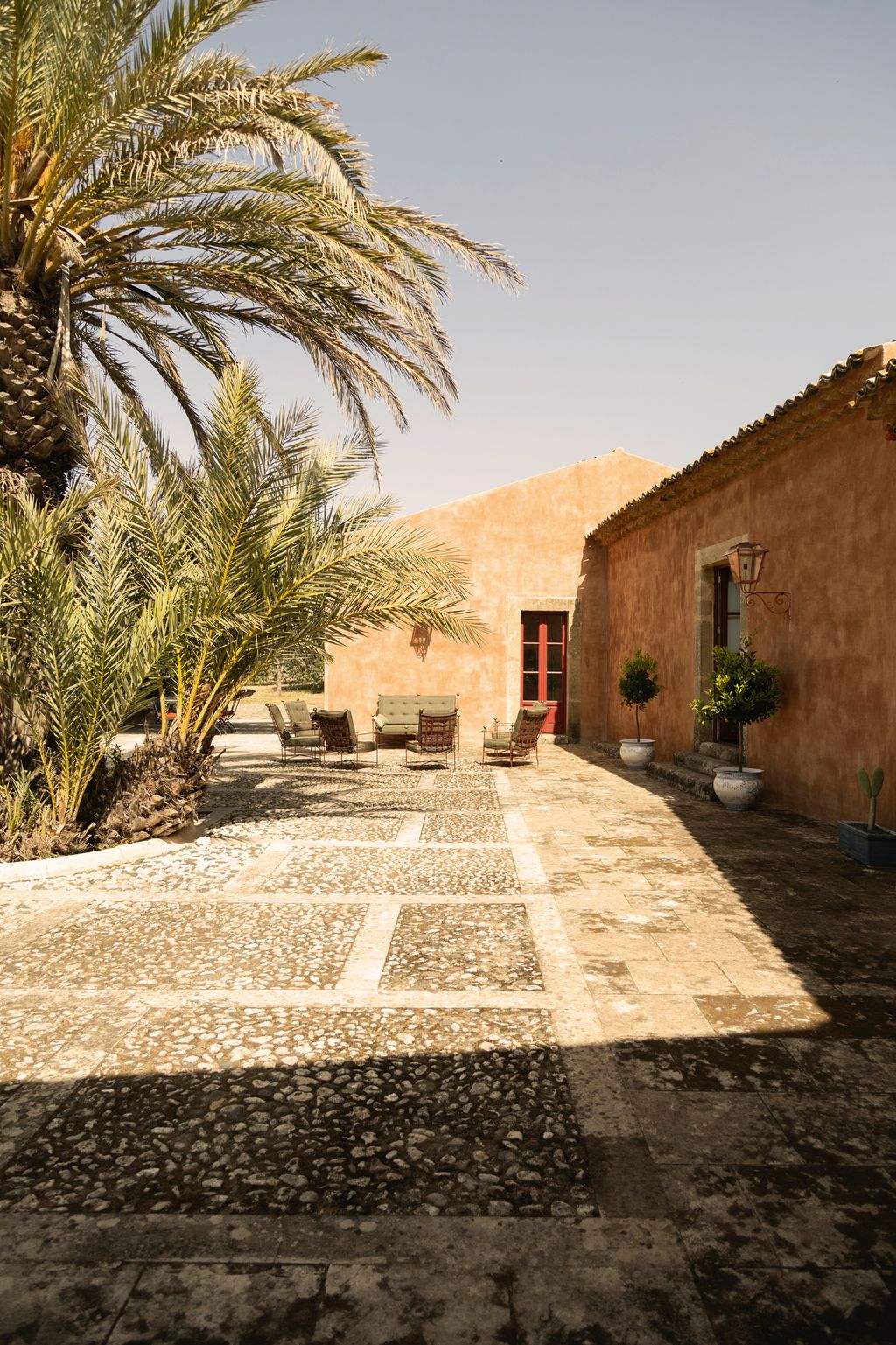 Image may contain Architecture Building House Housing Villa Plant Floor Lamp Chair Furniture and Outdoors